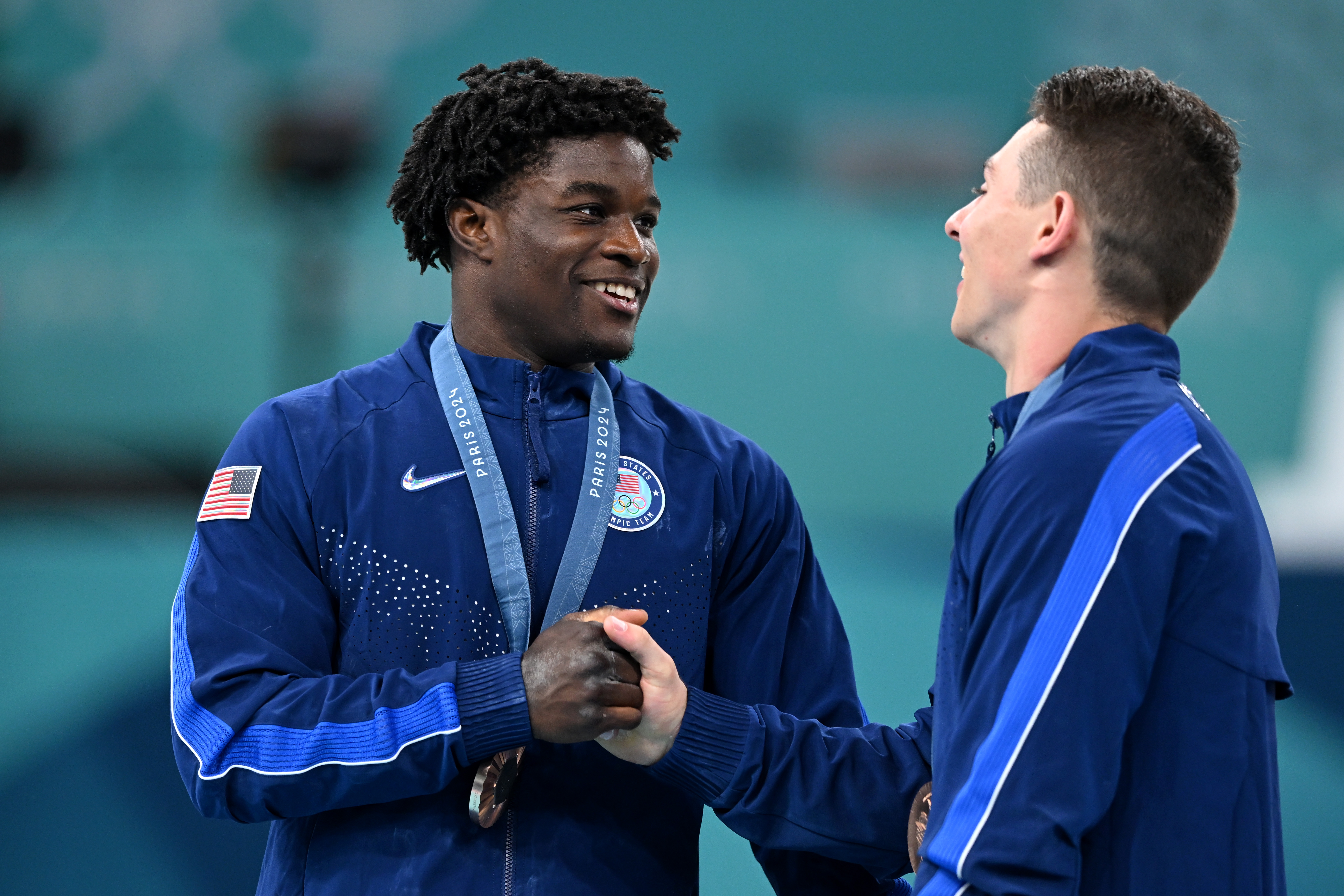 Frederick Richard and Paul Juda celebrate their bronze medal after the Men's Team Final at the Paris 2024 Olympics on July 29, 2024 | Source: Getty Images