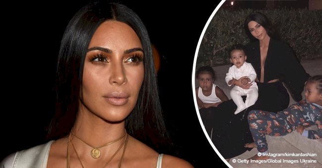 Kim Kardashian goes braless as she flaunts plunging cleavage in rare photo with all 3 kids