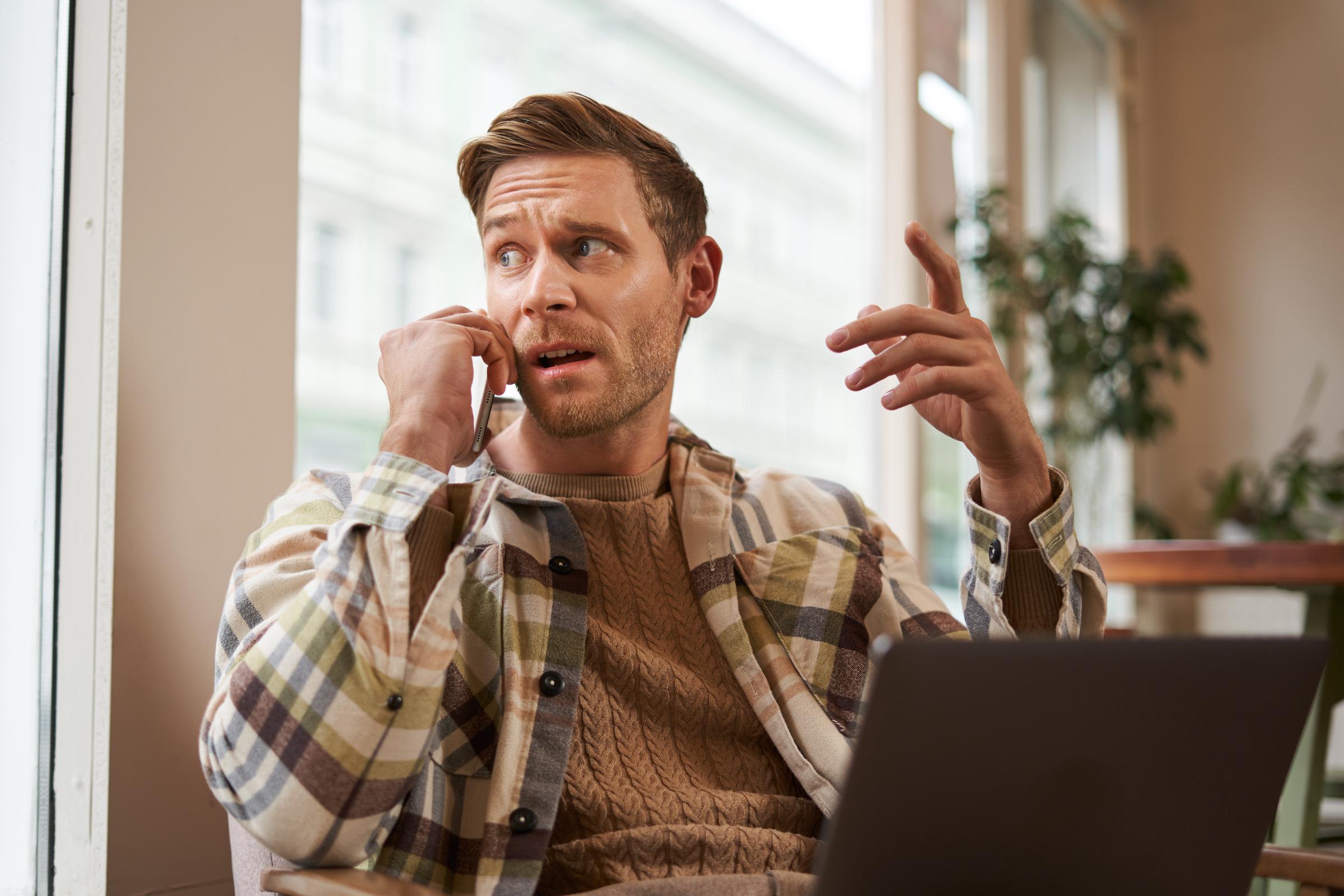 A concerned man talking on his phone | Source: Freepik