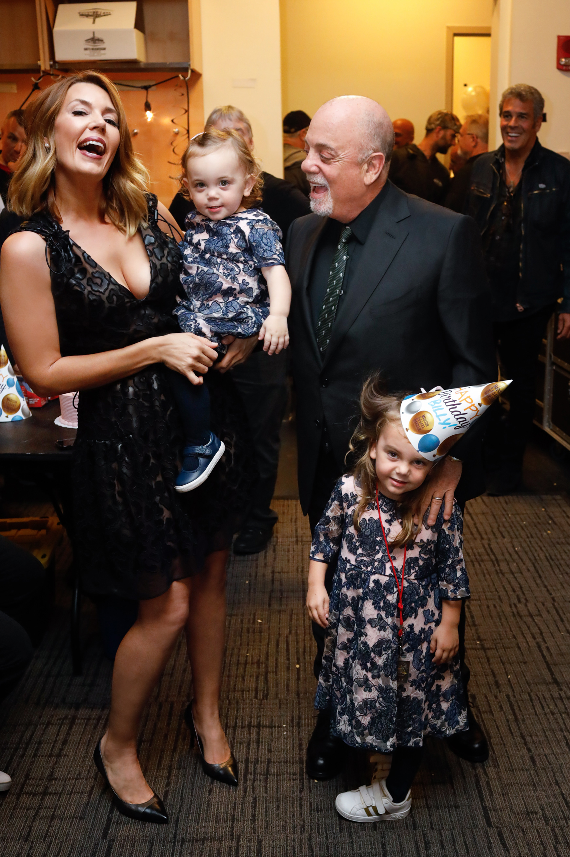 Alexis and Billy Joel celebrate with Remy Anne and Della Joel backstage on Joel's 70th Birthday and the 64th consecutive show of his residency at Madison Square Garden on May 9, 2019, in New York City | Source: Getty Images