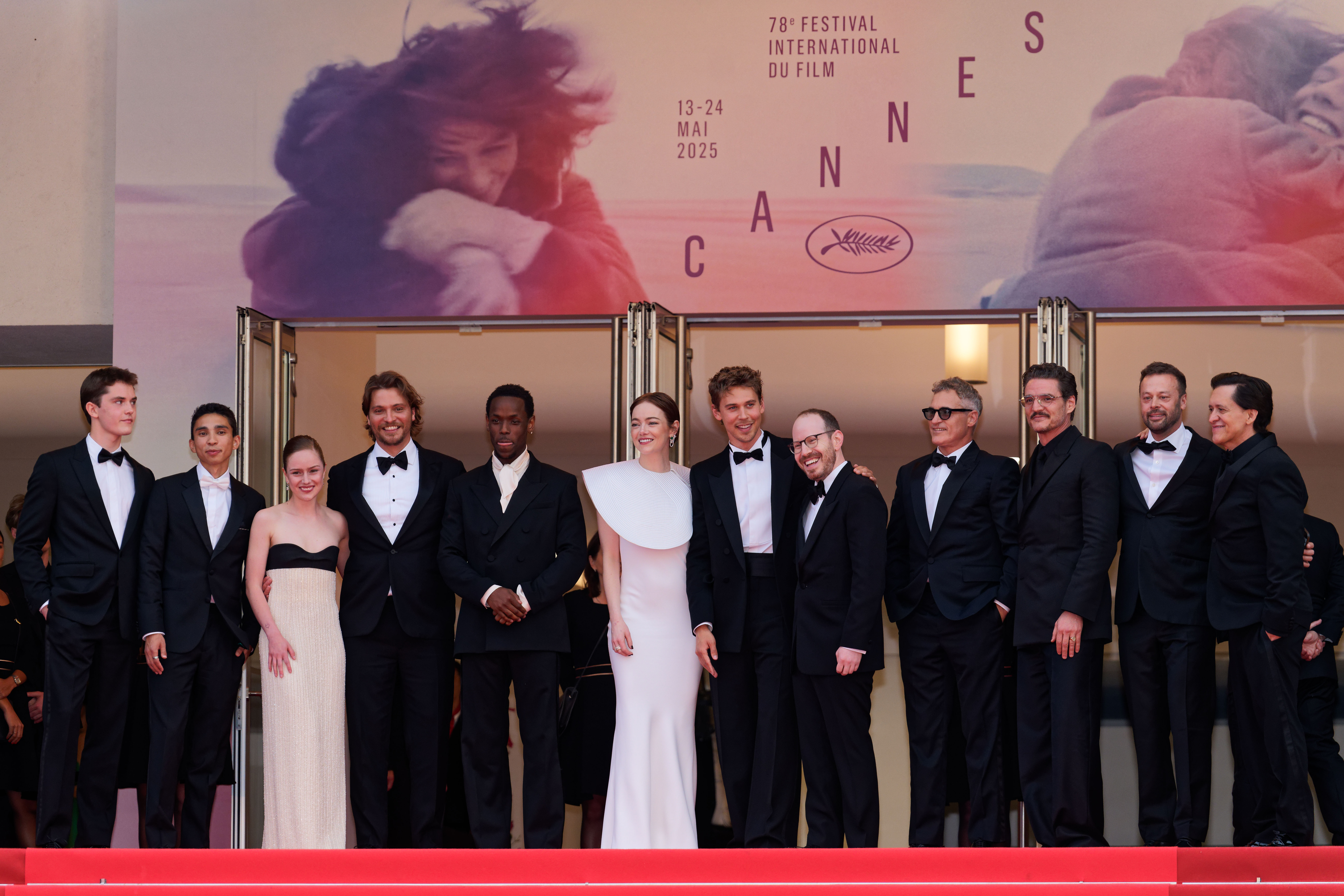 The cast and creatives of "Eddington" at the top of the Palais des Festivals steps. Pictured from left to right: Cameron Mann, Matt Gomez Hidaka, Amélie Hoeferle, Luke Grimes, Micheal Ward, Emma Stone, Austin Butler, Ari Aster, Joaquin Phoenix, Lars Knudsen, Pedro Pascal, and Clifton Collins Jr.