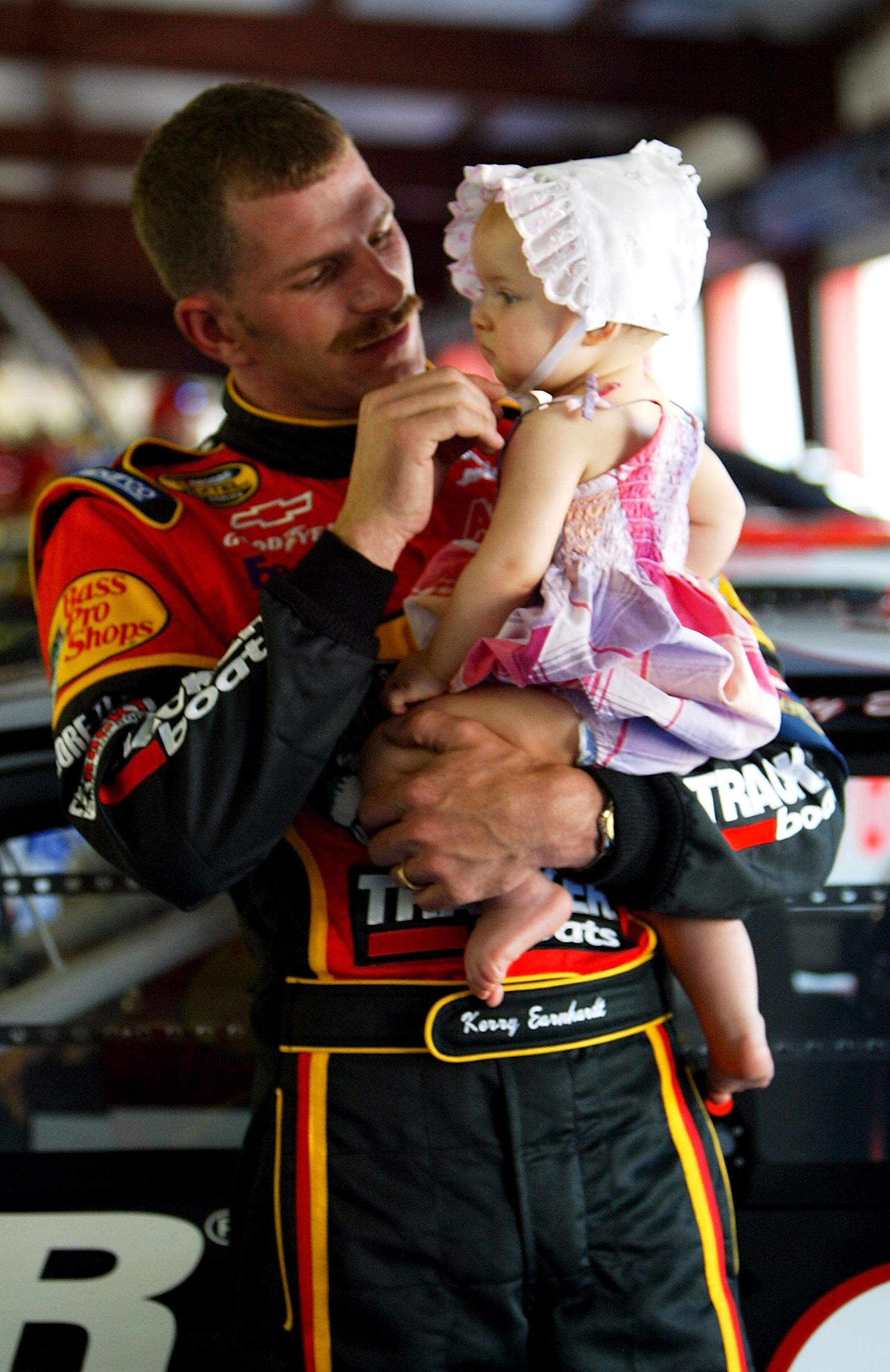 Kerry Earnhardt holds daughter Kaylan in the garage during practice for the Aaron's 499 on April 24, 2004, at Talladega SuperSpeedway, in Talladega, Alabama. | Source: Getty Images