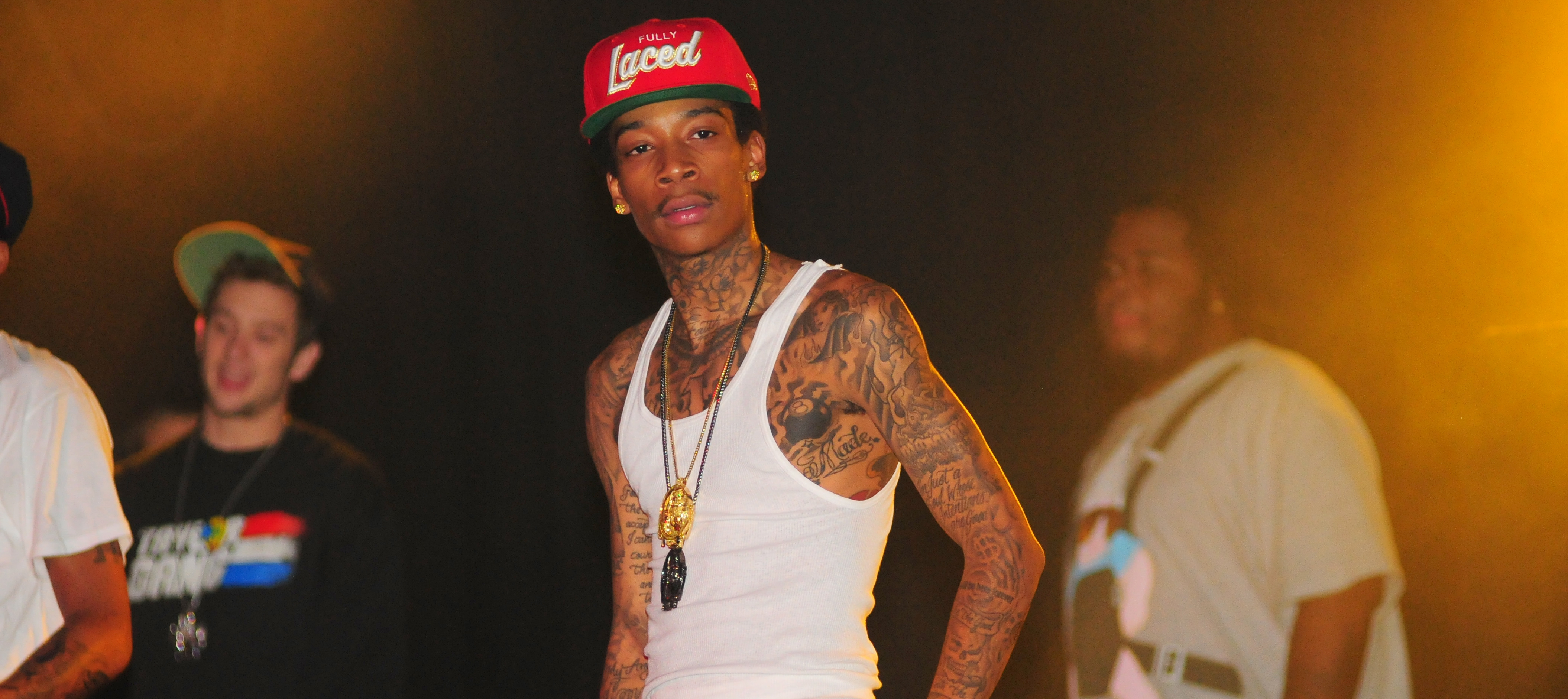 In this November 6, 2010 photo, Wiz Khalifa performs at The Masquerade in Atlanta, Georgia, showcasing the slim frame that defined much of his early career. Dressed in a white tank top that highlighted his lanky build, the rapper was still years away from the MMA training regimen that would eventually transform his physique.