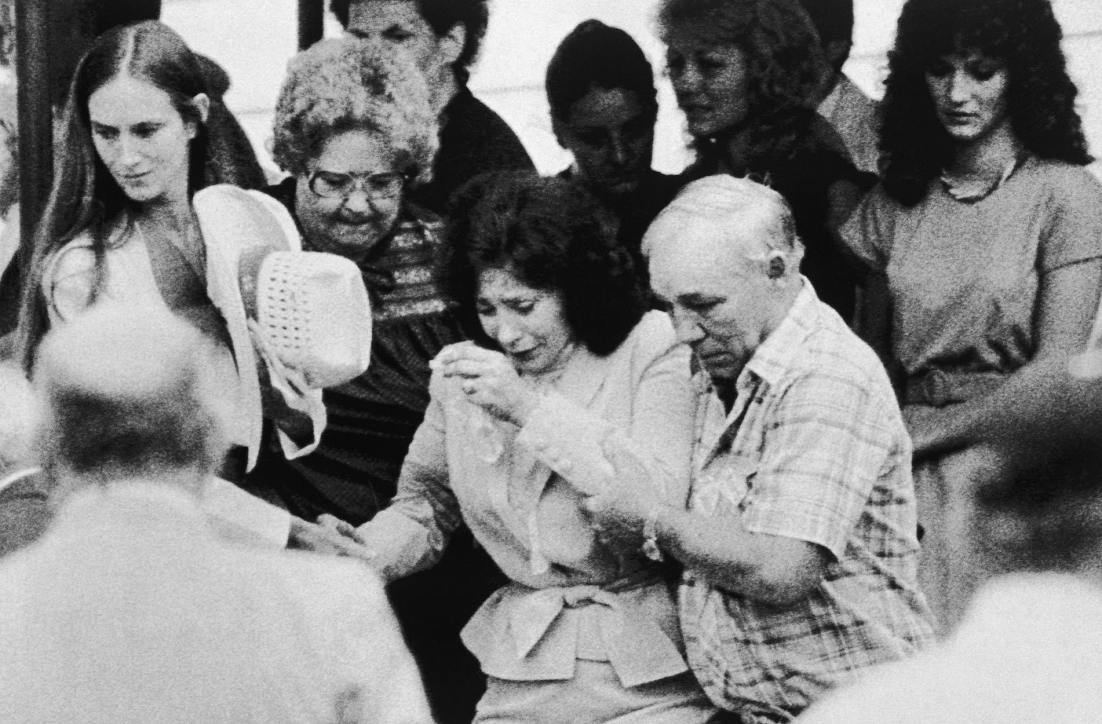 Country music queen Loretta Lynn, center, is assisted by her husband, Mooney,  on July 27, 1984, in Waverly, Tennessee, as they leave the funeral of their son | Source: Getty Images