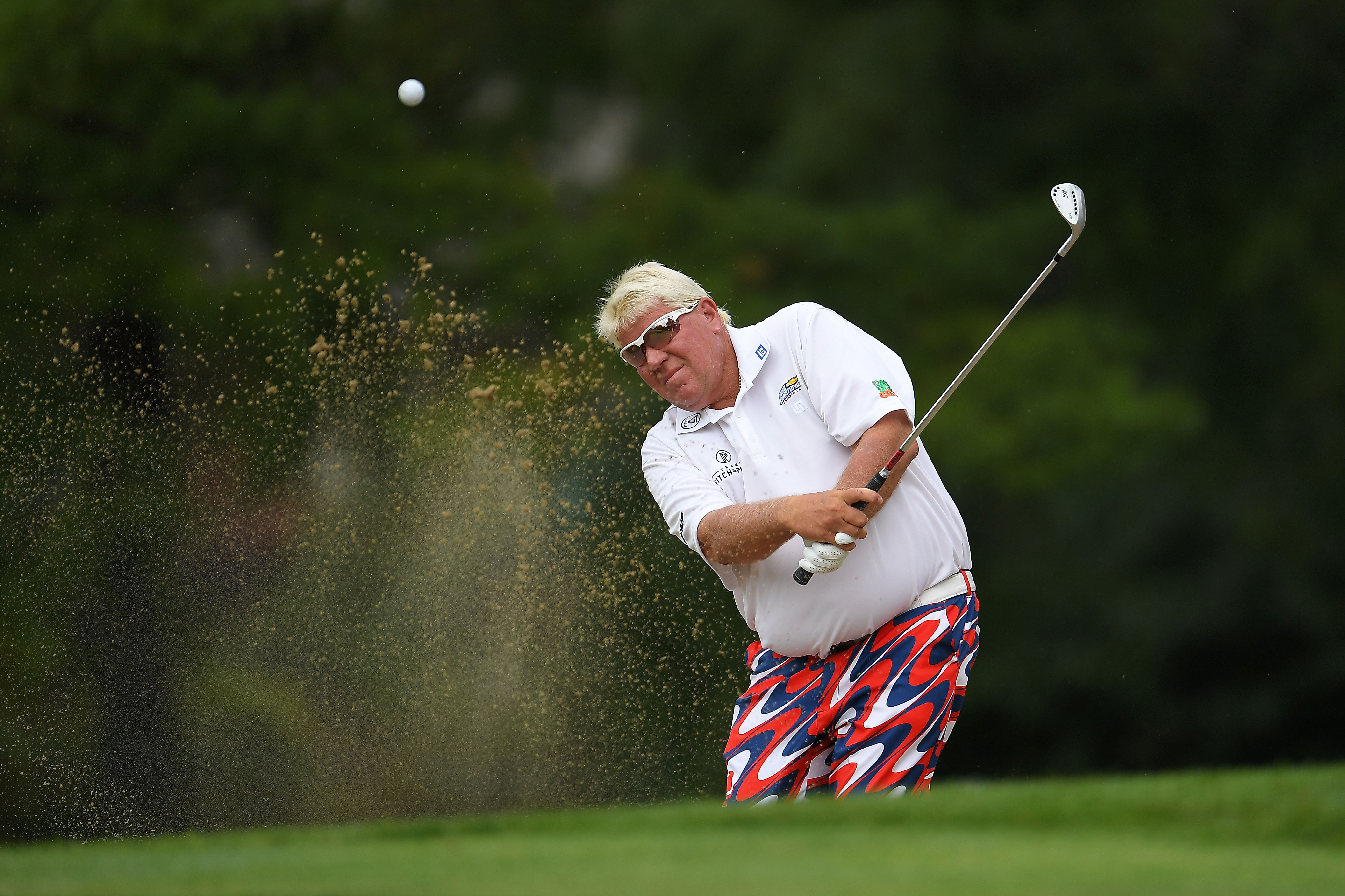 John Daly hits from a green side bunker at Warwick Hills Golf & Country Club on September 14, 2018, in Grand Blanc, Michigan. | Source: Getty Images.