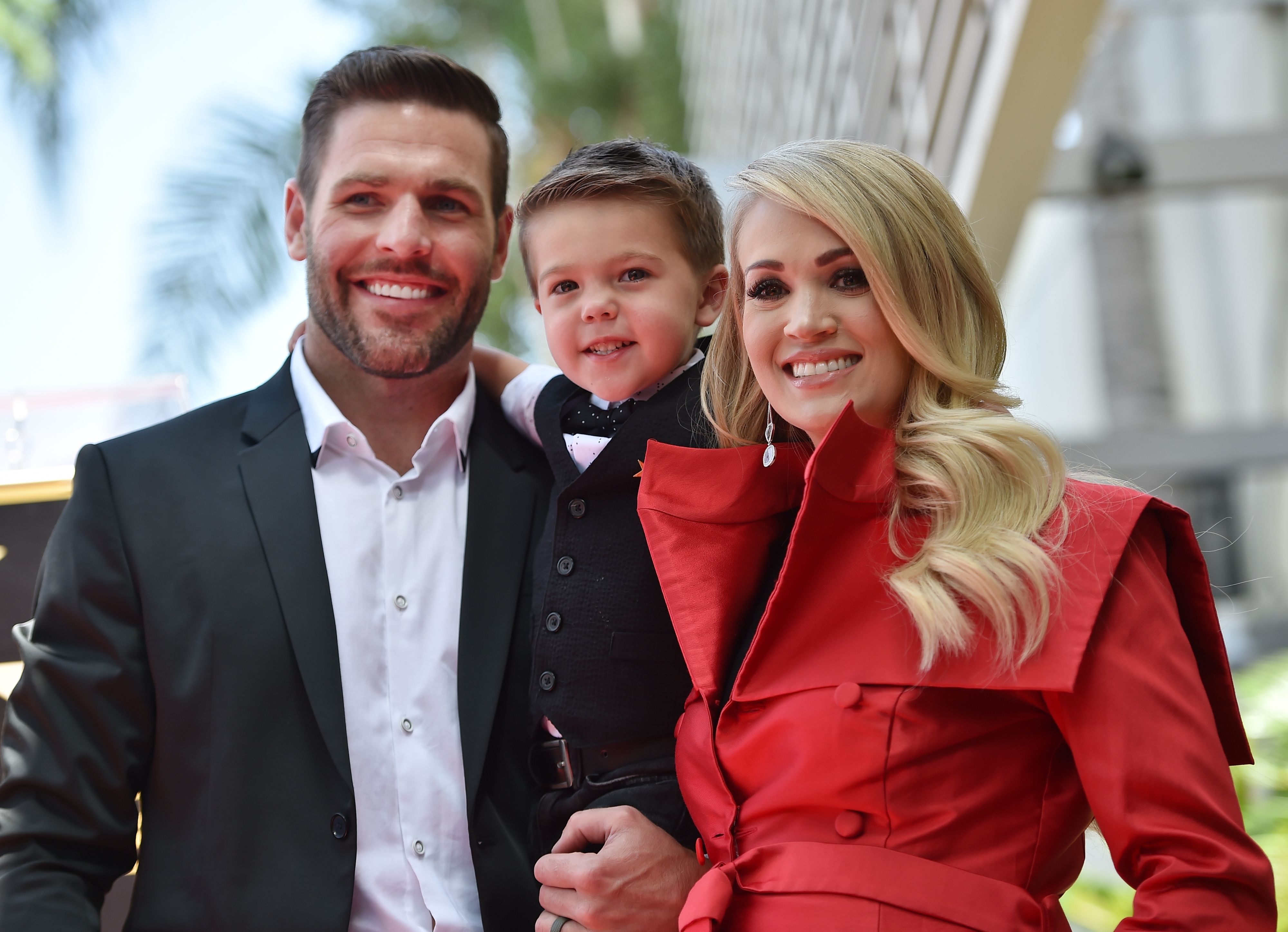 Carrie Underwood poses with her husband Mike Fisher and their 3-year-old son Isaiah Michael at her star unveiling ceremony on the Hollywood Walk of Fame, September 20, 2018 in Hollywood, California | Source: Getty Images