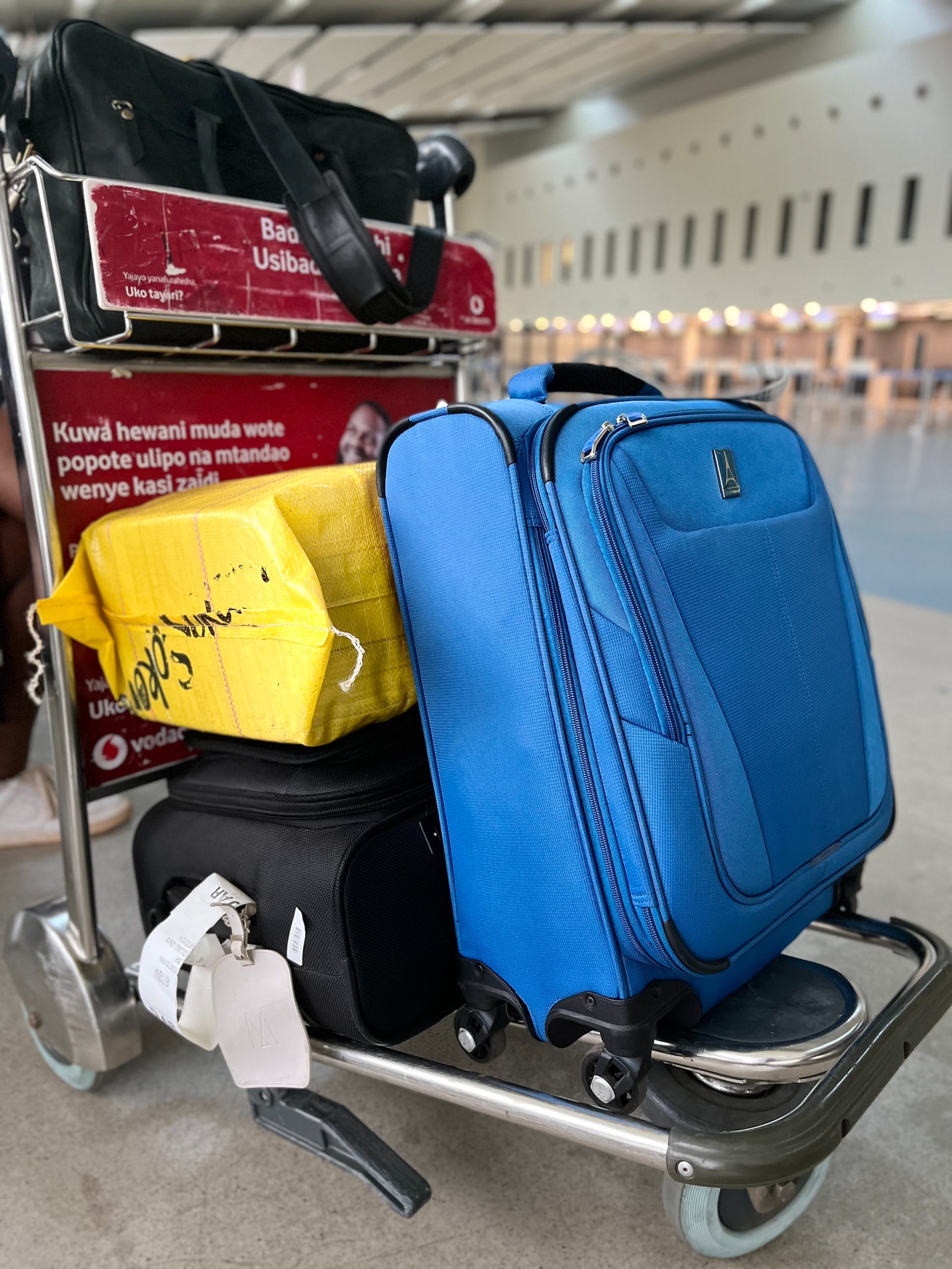 Luggage on a trolley at an airport | Source: Pexels