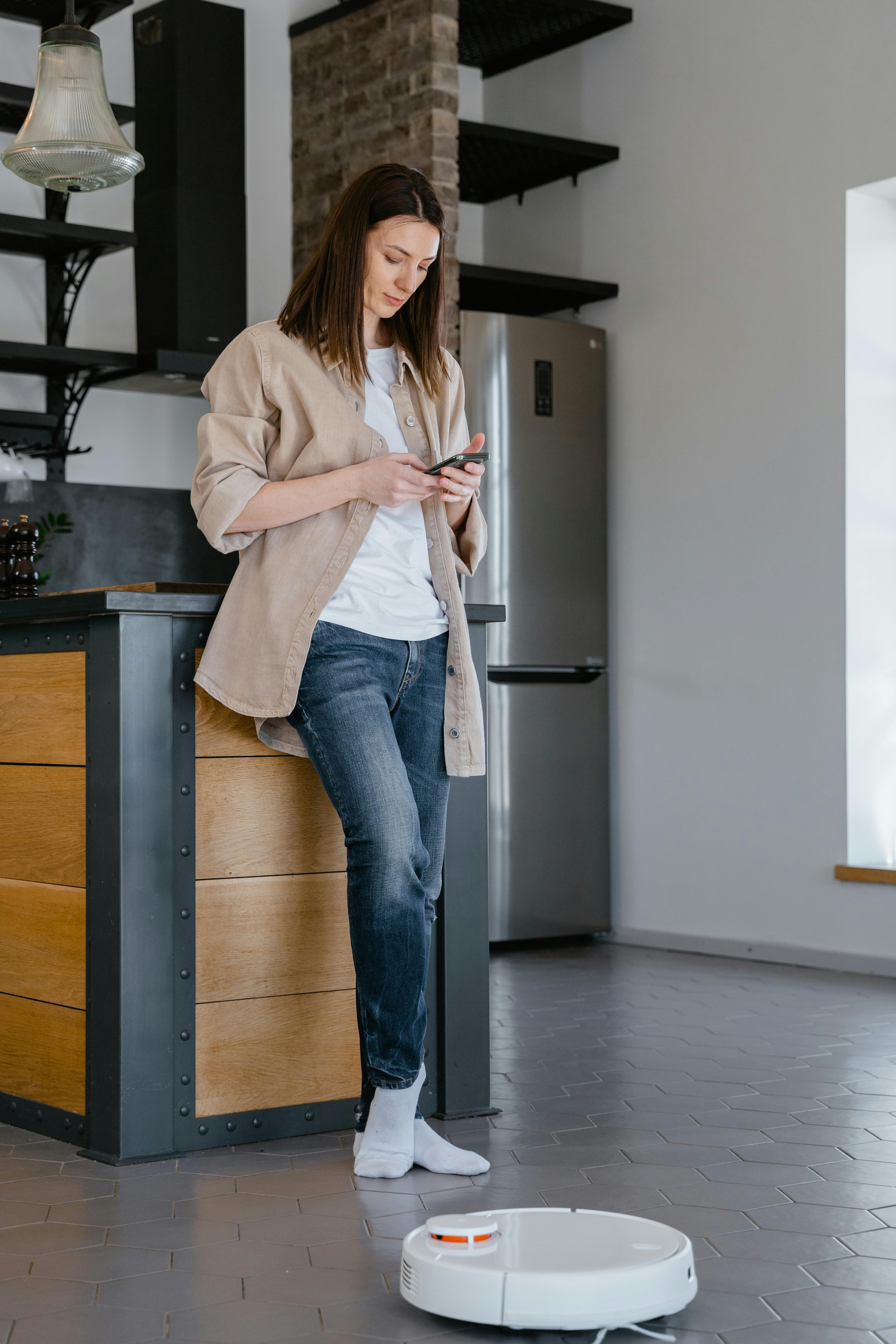 A woman operating her smart appliance | Source: Pexels