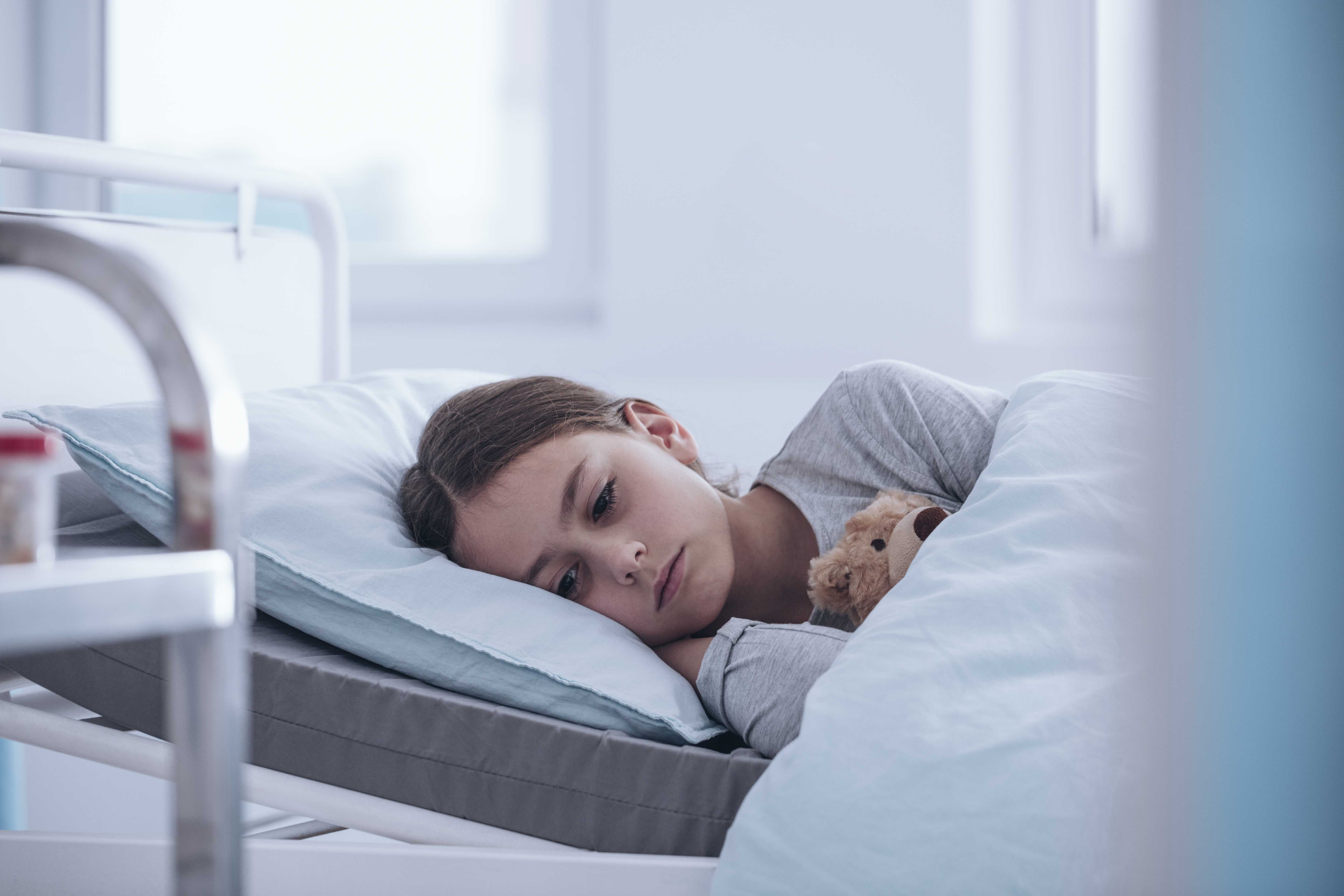 Sad girl is lying in hospital ward | Source: Shutterstock.com