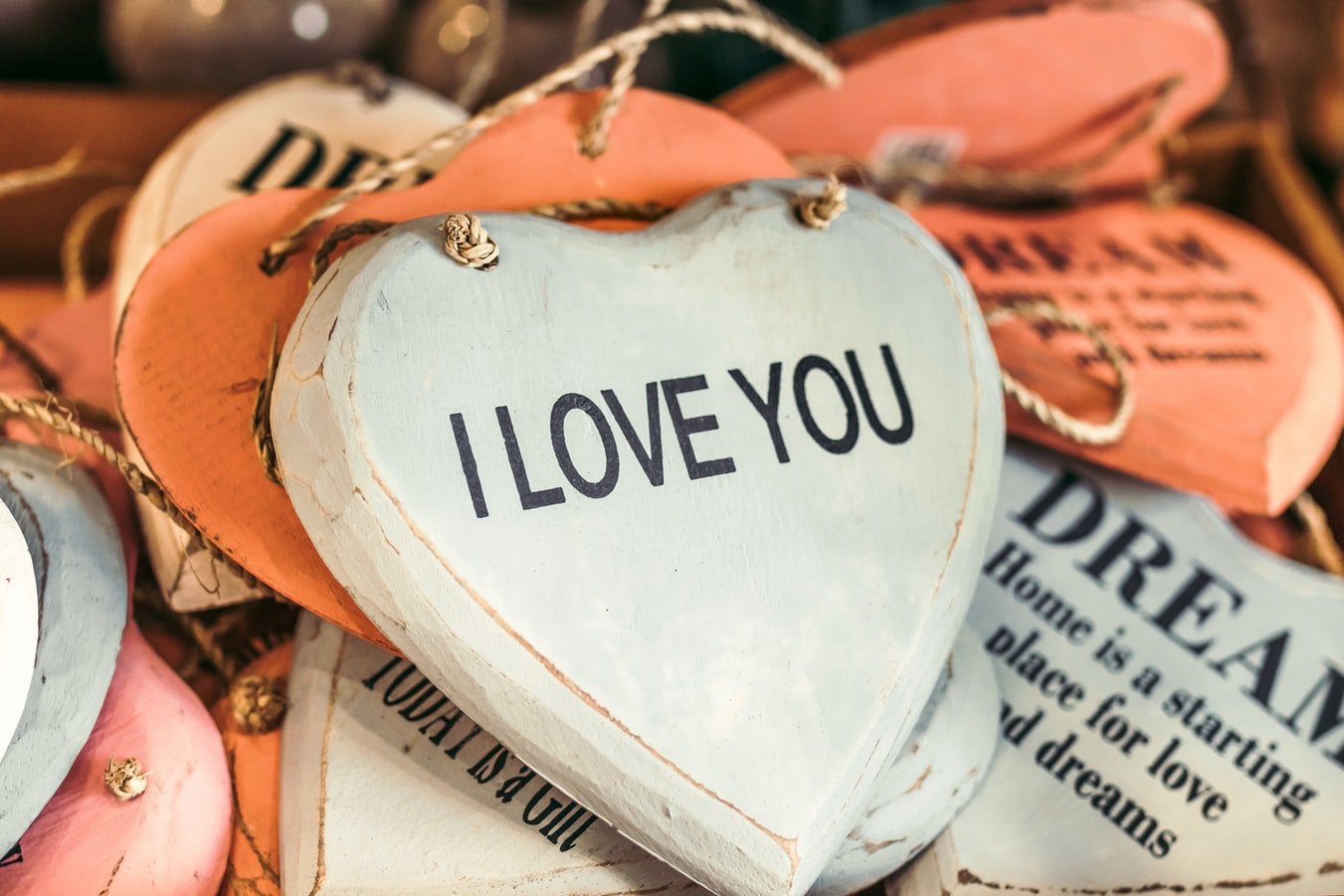 "Ich liebe dich" auf einem Holzherzen | Quelle: Unsplash