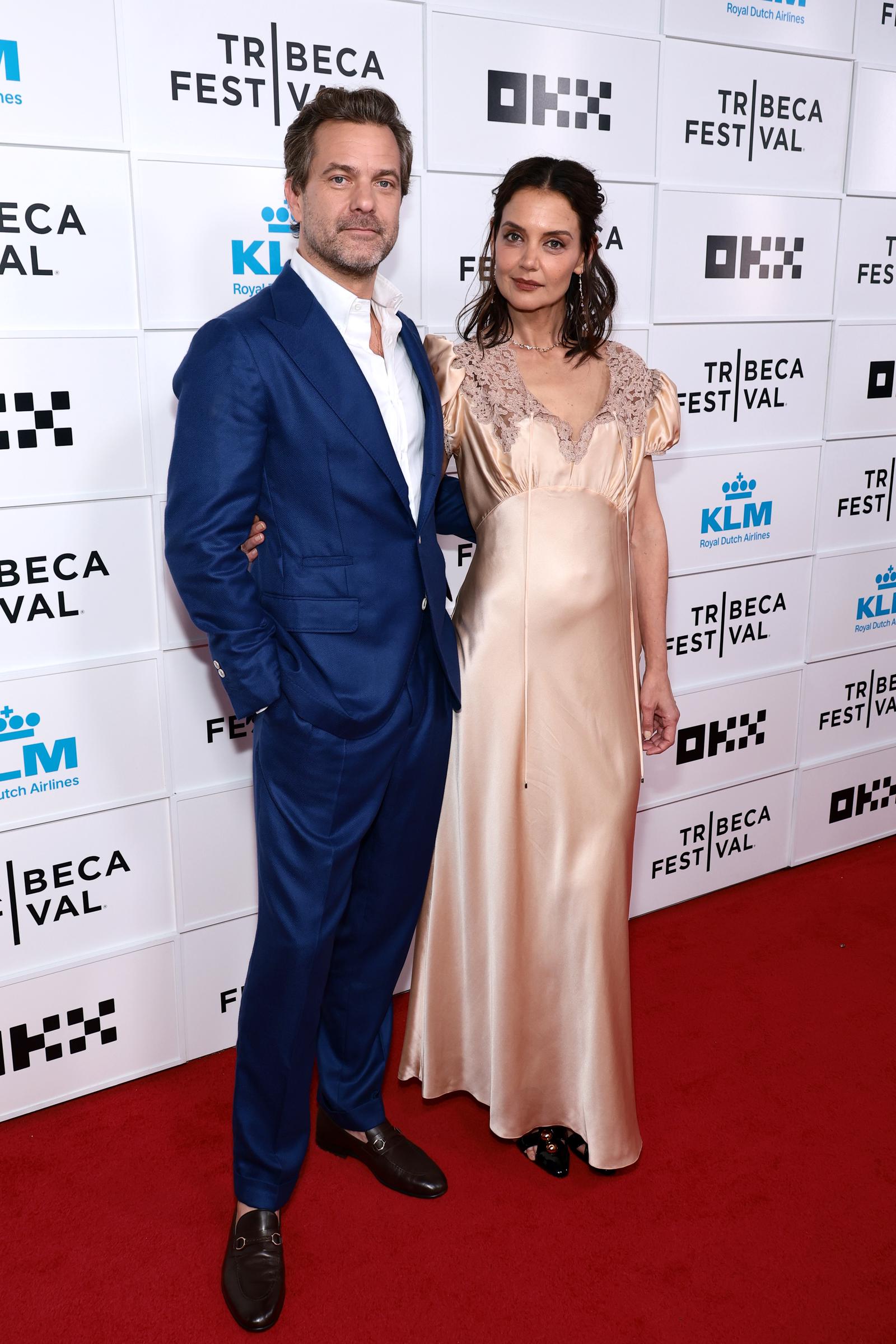 Katie Holmes and Joshua Jackson pose at the "Happy Hours" premiere during the 2026 Tribeca Festival in New York City. Holmes' champagne-colored gown became a talking point among fans online. | Source: Getty Images