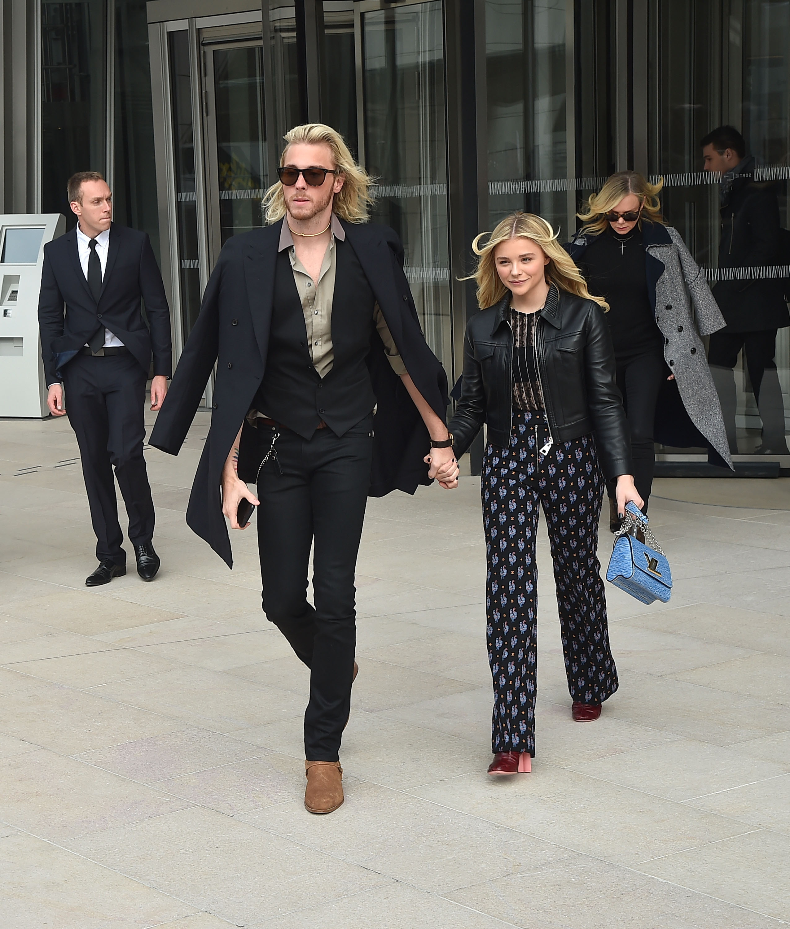 Chloe Grace Moretz and Trevor Moretz depart the Louis Vuitton show in Paris on 11 March 2015. | Source: Getty Images
