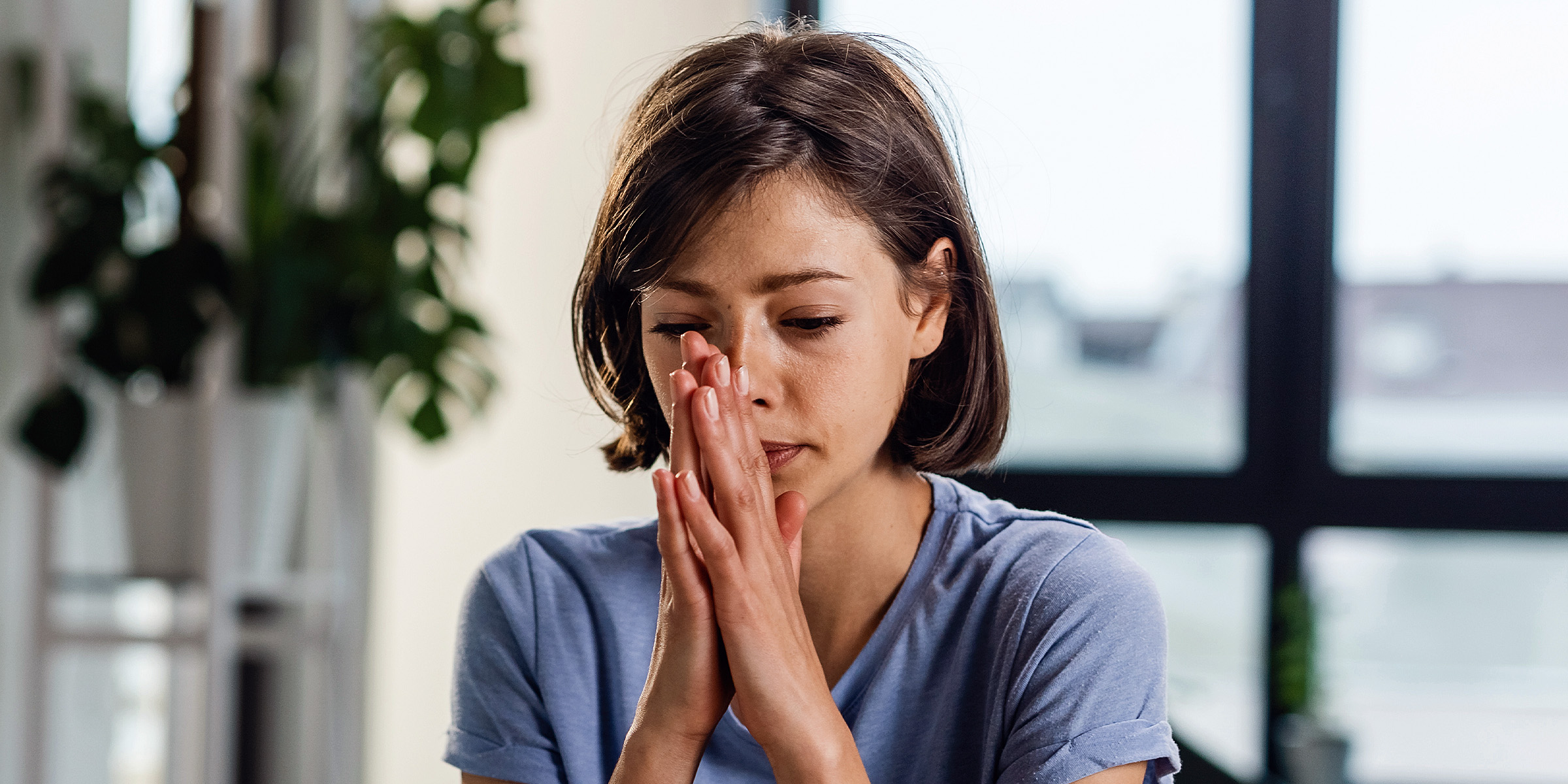 A woman sitting with her palms together | Source: Freepik