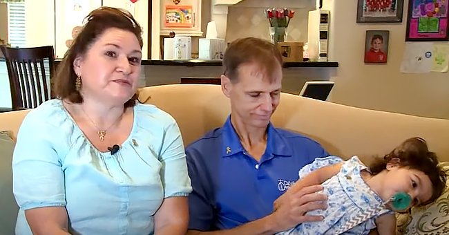 Mitch and Crissy Finnie and their child, Bridget in an interview | Photo:   youtube.com/kens5