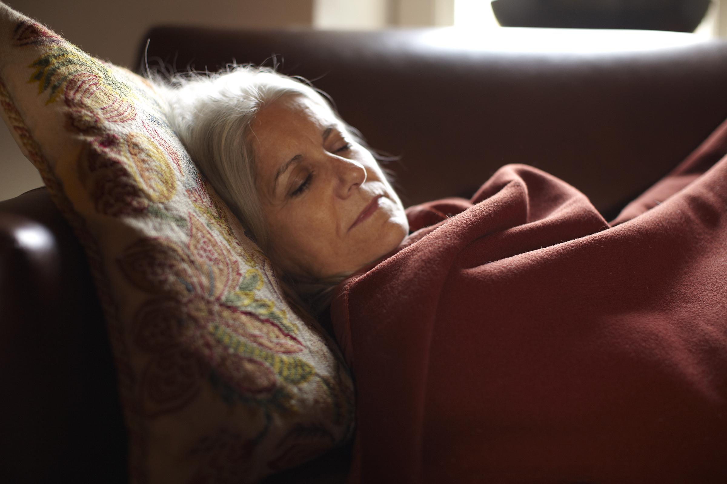 A woman taking a nap on her couch | Source: Getty Images