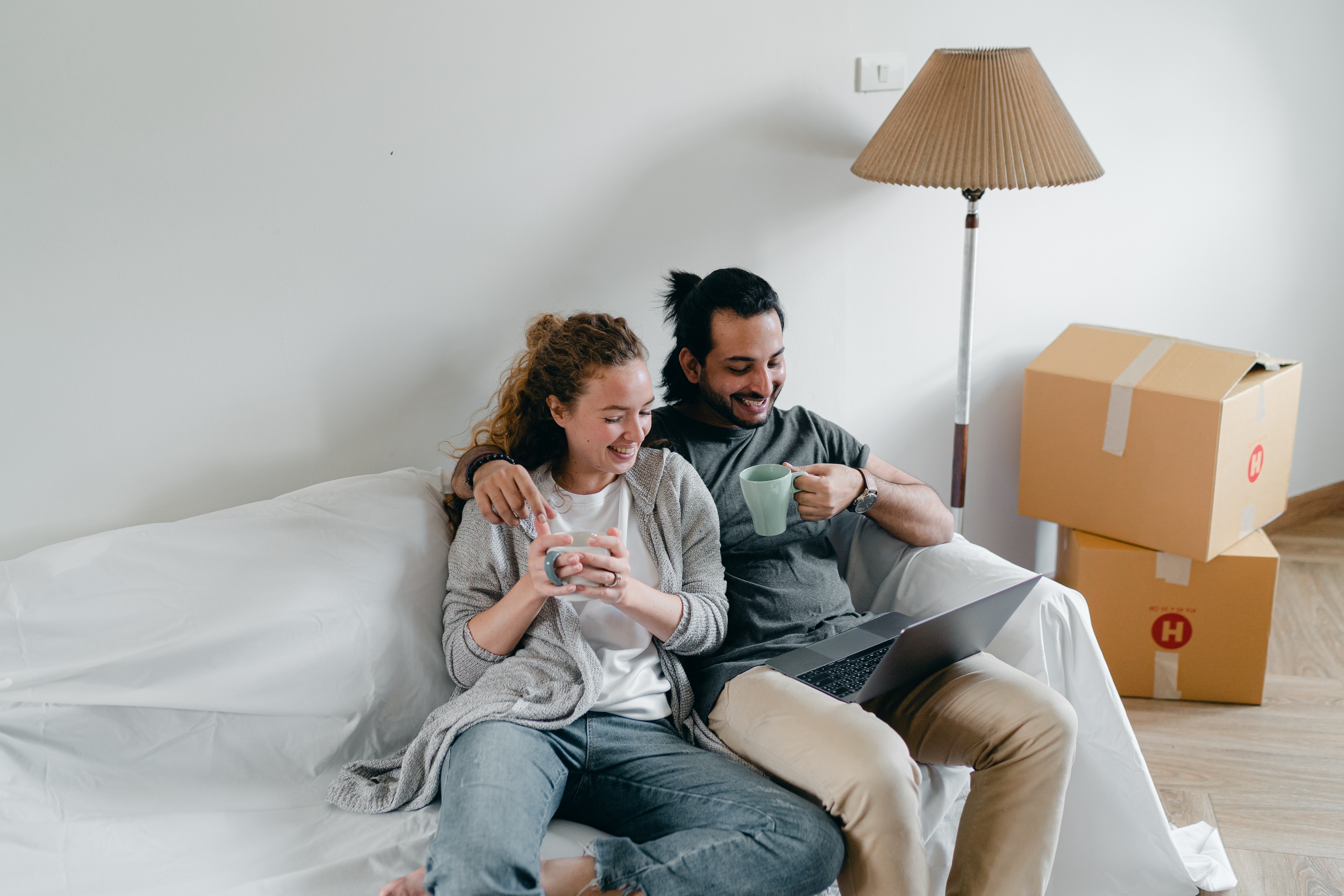 A couple watching a laptop at home. | Source: Pexels