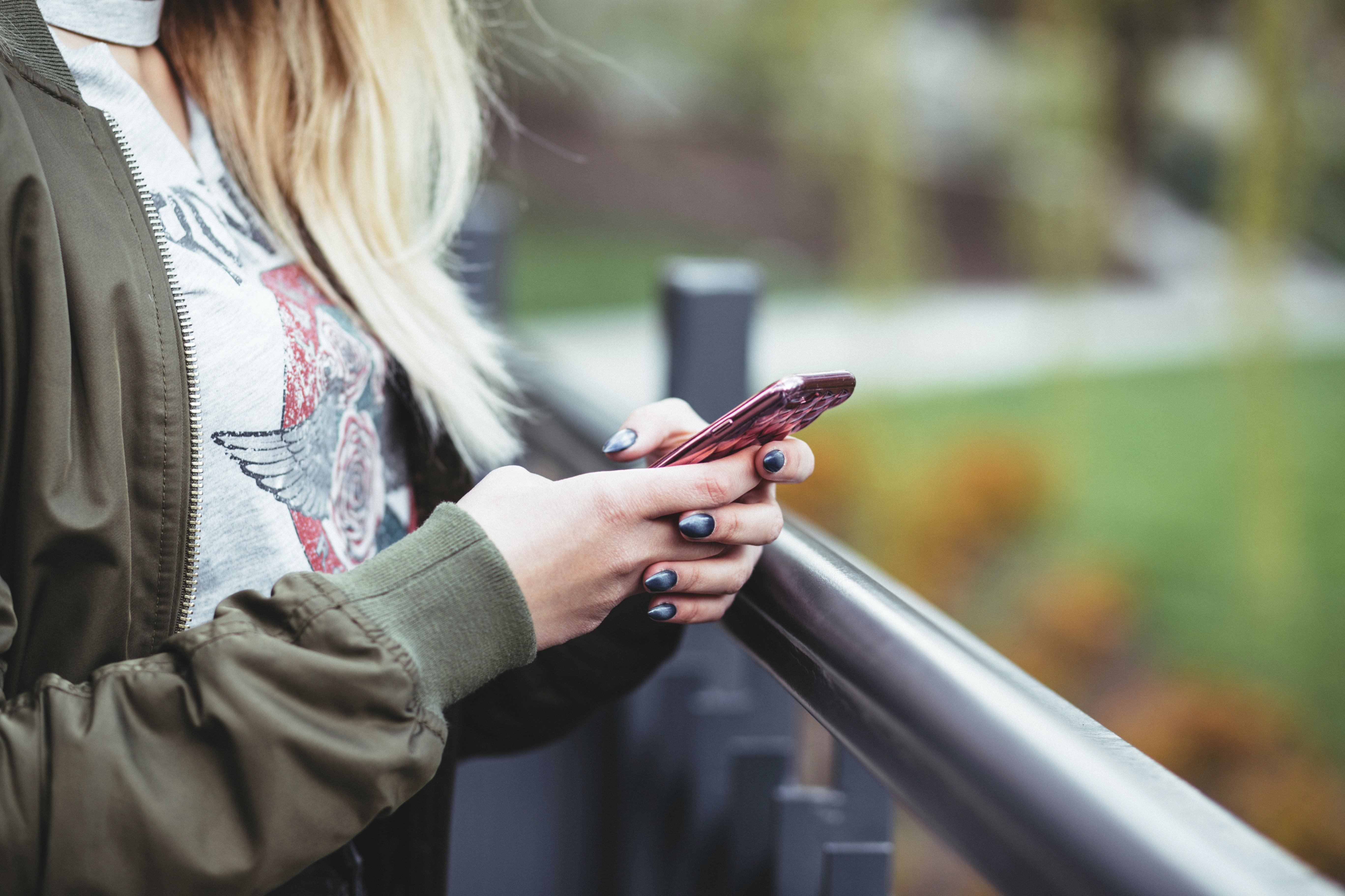 A woman using her phone. | Photo: Unsplash