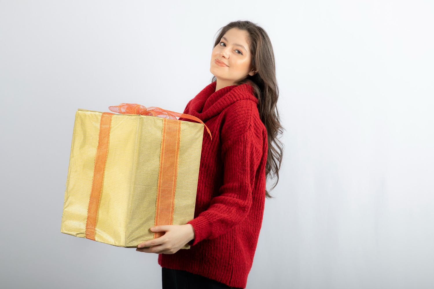 Woman with the wrapped box | Source: Freepik