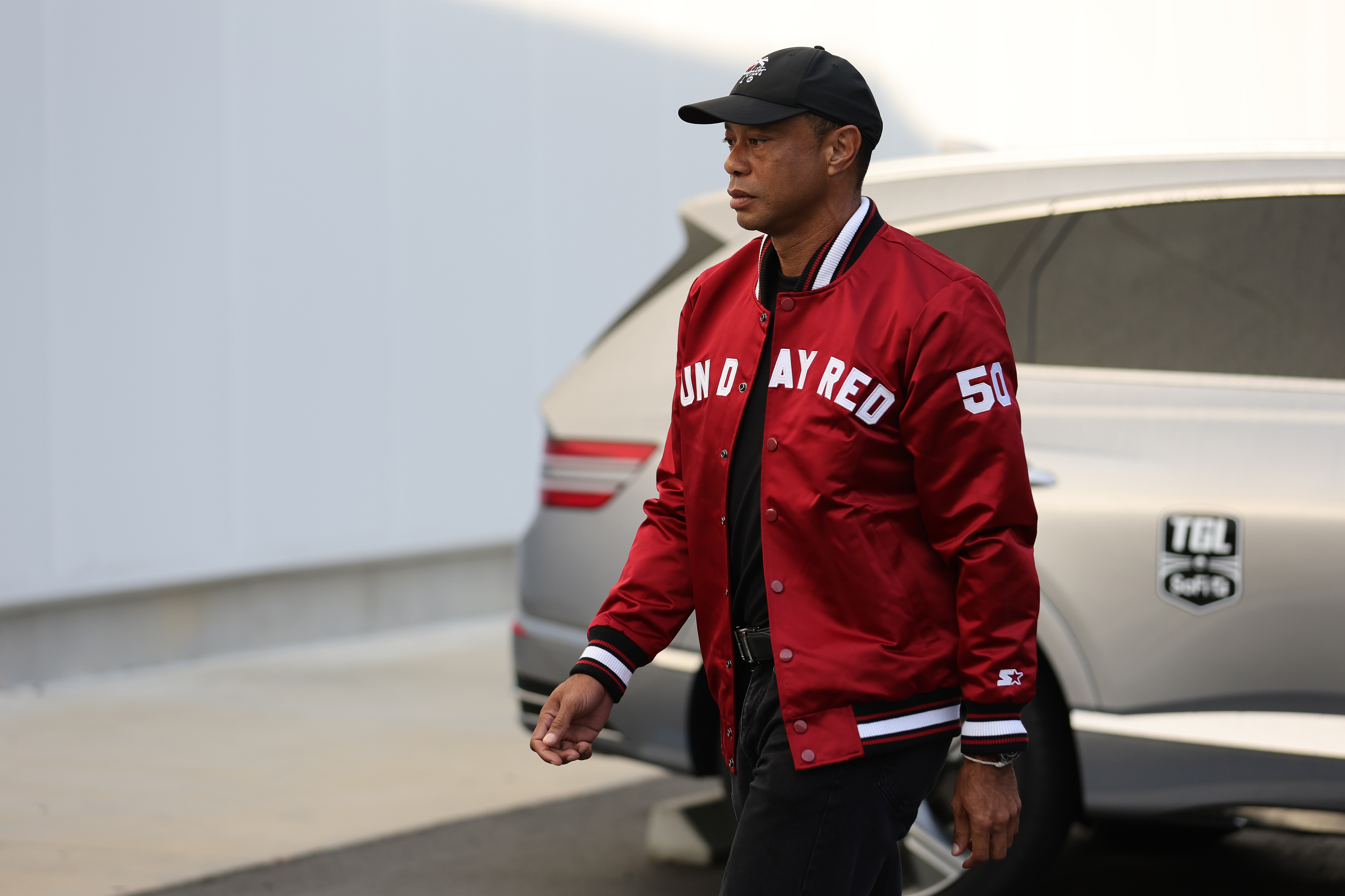 Tiger Woods arrives before the match against the New York Golf Club at SoFi Center in Palm Beach Gardens, Florida on January 13, 2026. | Source: Getty Images