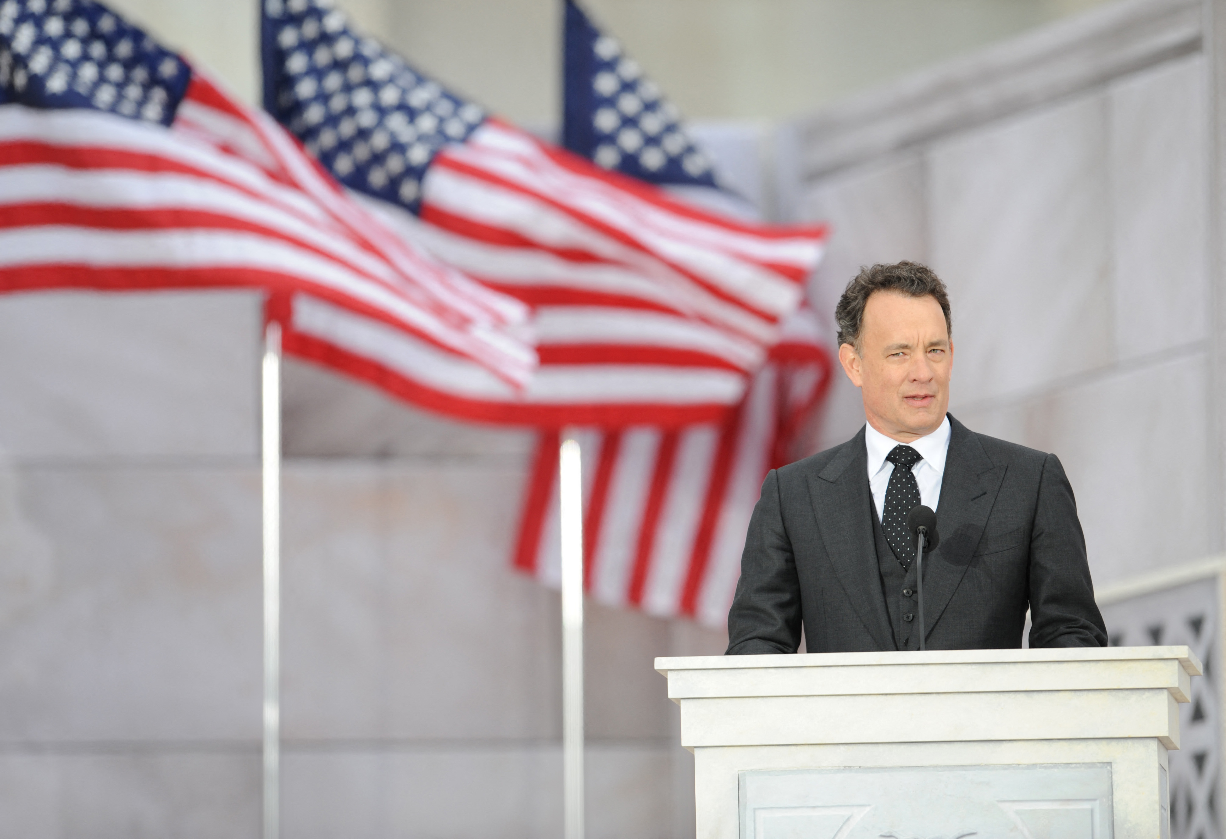 Tom Hanks reads a historical text at the 'We Are One" concert during one of the events of US president-elect Barack Obama's inauguration celebrations, at the Lincoln Memorial in Washington on January 18, 2009 | Source: Getty Images