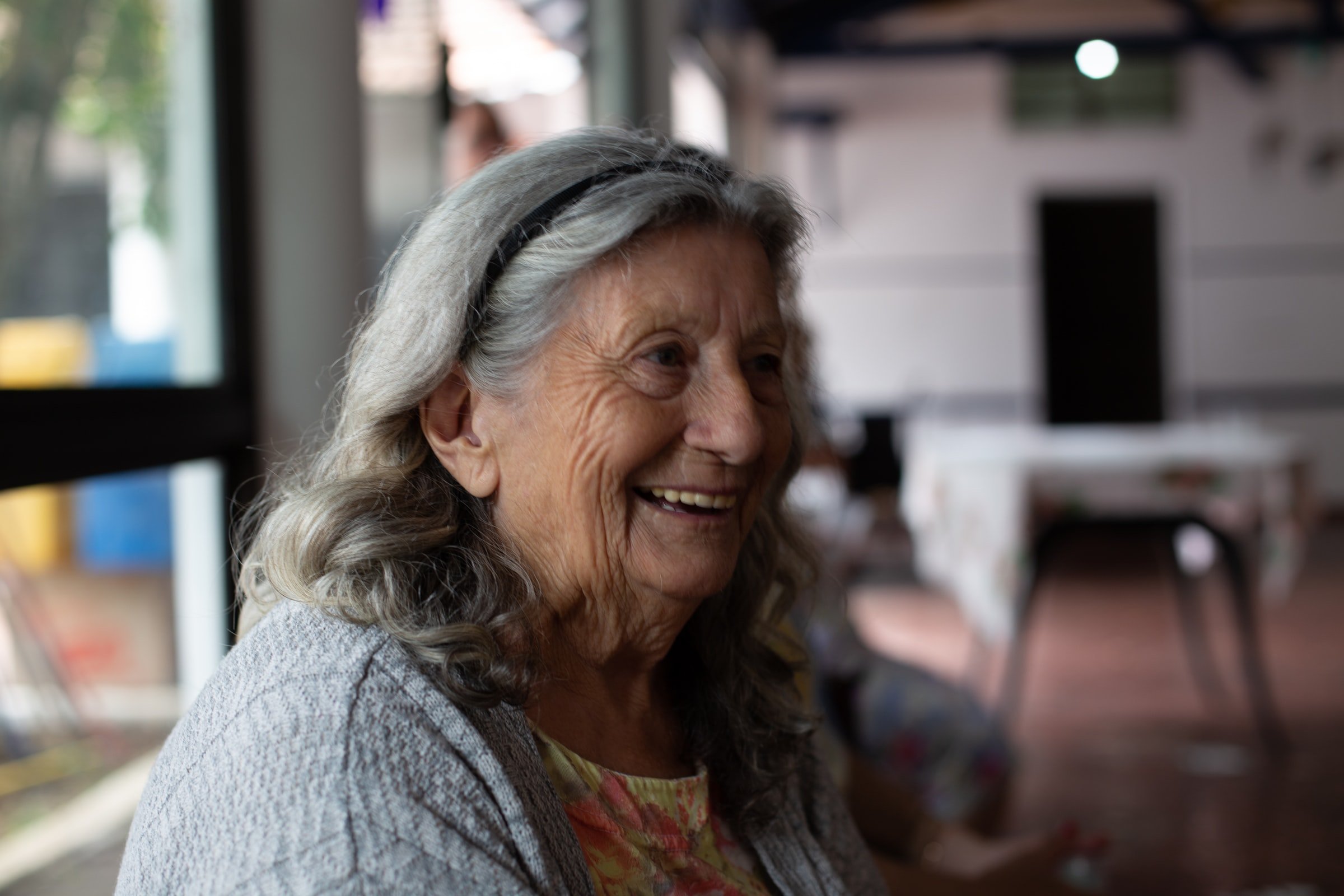 Elderly woman smiling. | Source: Unsplash