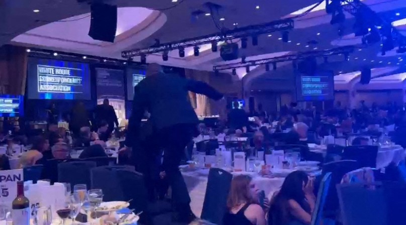 Agents climb over chairs as they move to the stage after loud bangs were heard during the White House Correspondents' dinner on April 25, 2026 | Source: Getty Images