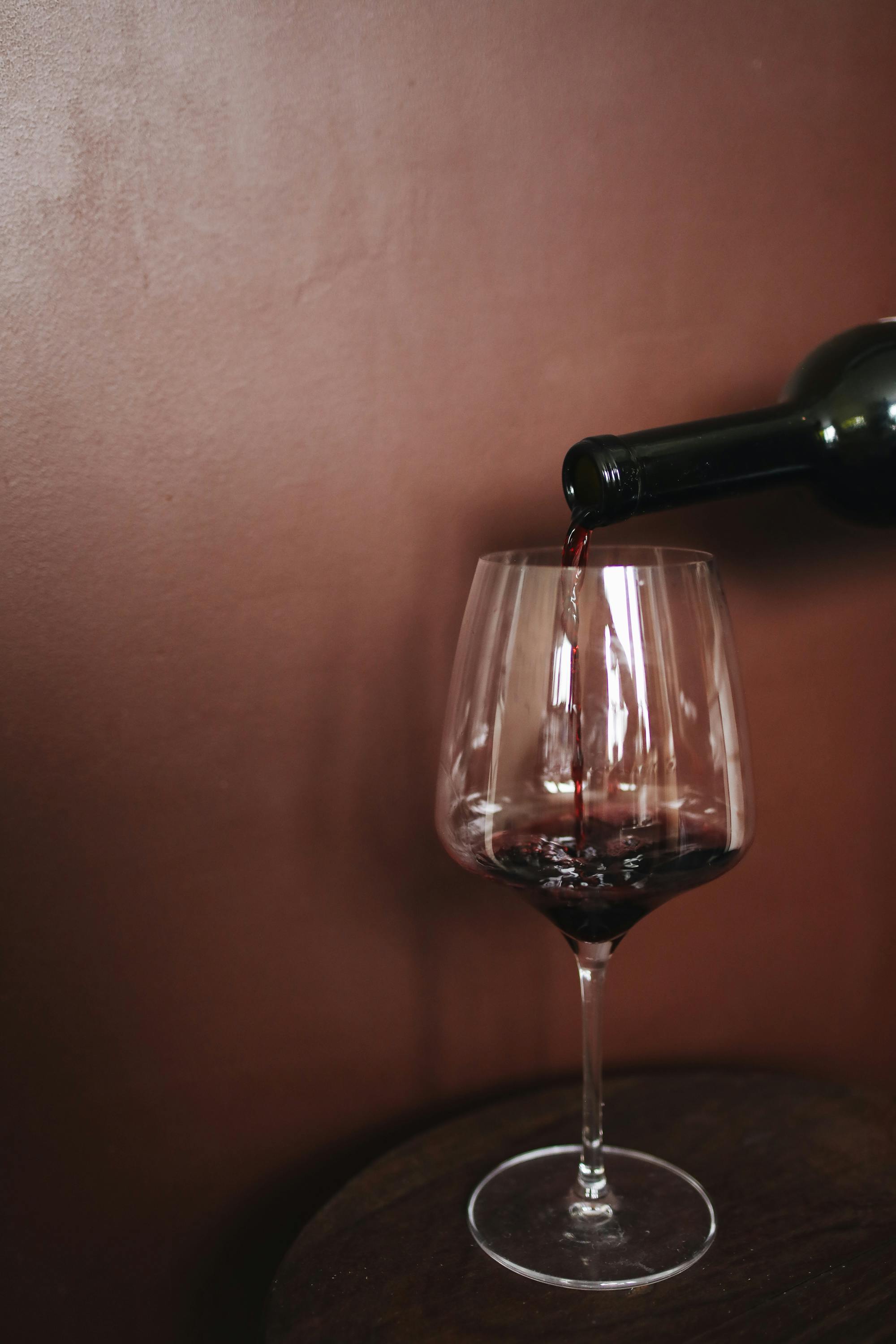 Wine being poured into a wine glass | Source: Pexels