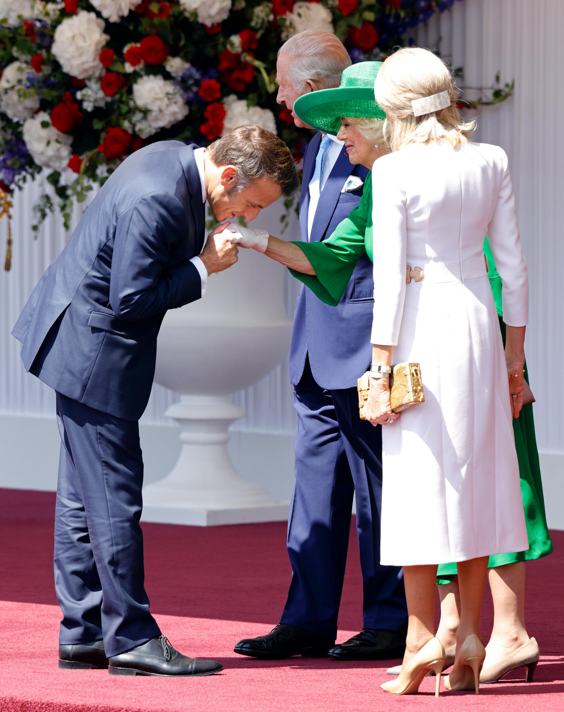 President Emmanuel Macron kissing Queen Camilla's hand on July 8, 2025, in Windsor, England. | Source: Getty Images