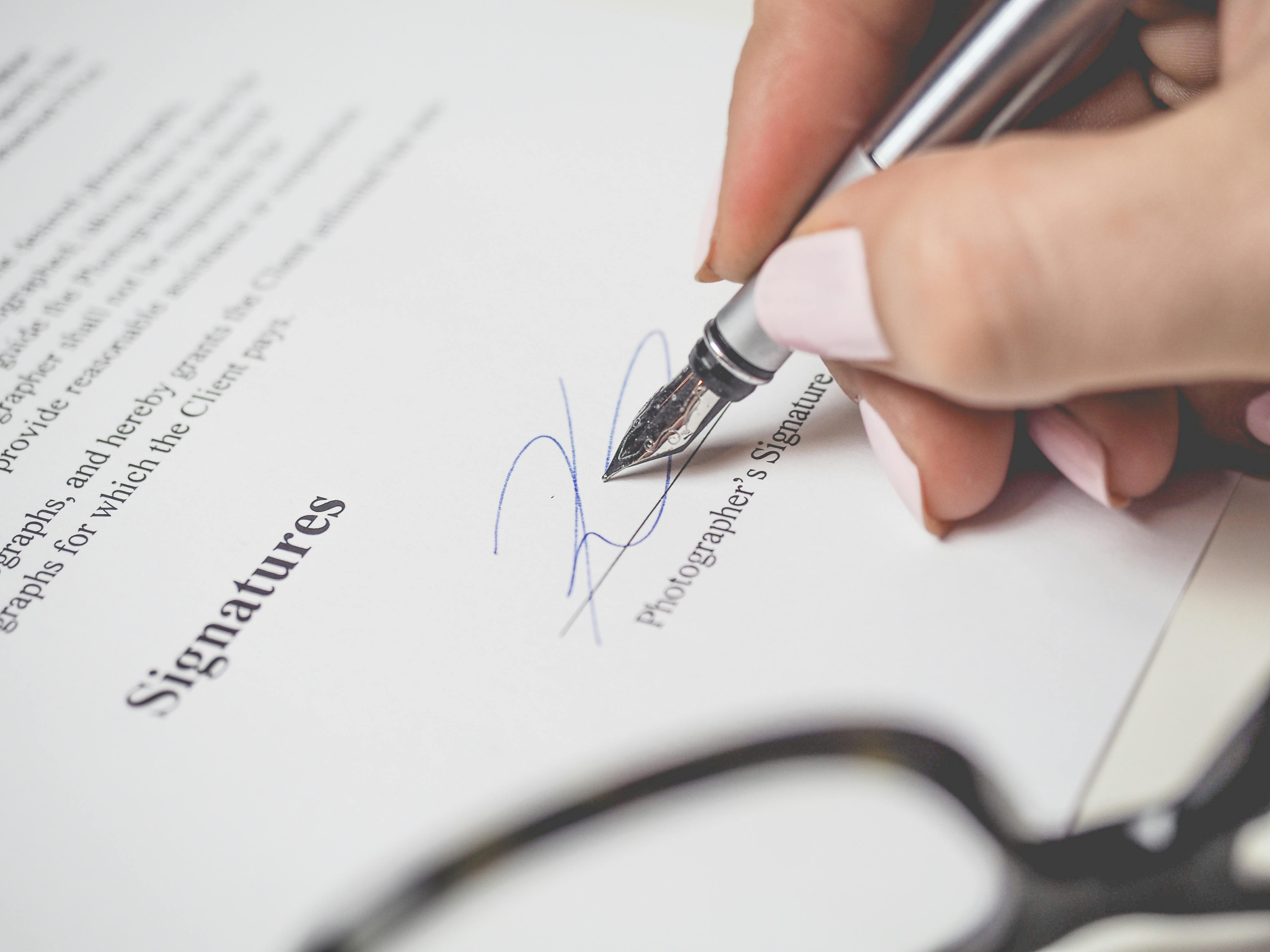 Signing a paper | Source: Pexels