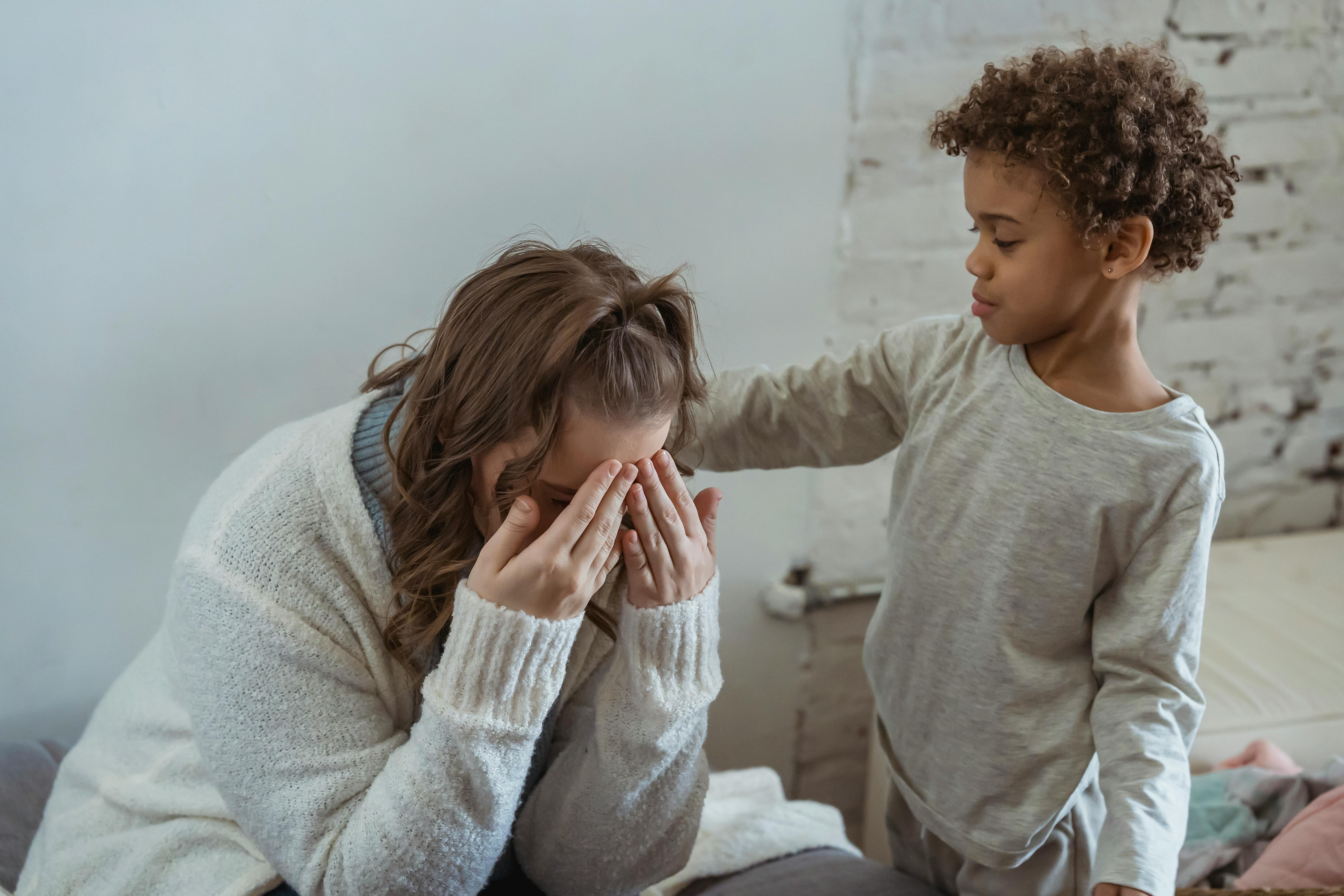 Claire's son, Noah, comforts her after she loses her job | Source: Pexels
