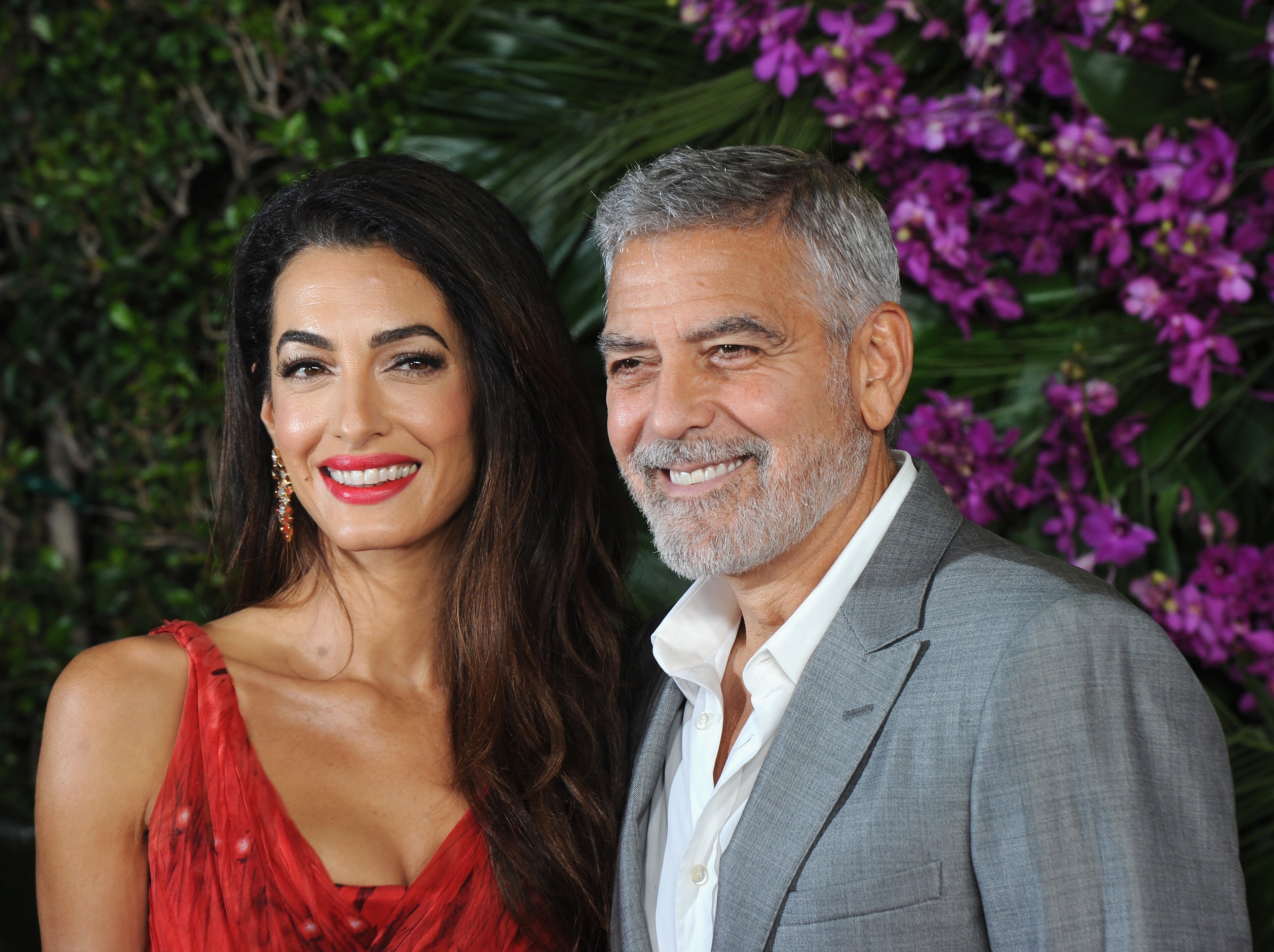 George Clooney and his wife Amal Clooney attend the premiere of Universal Pictures' "Ticket To Paradise" held at Regency Village Theatre on October 17, 2022 in Los Angeles, California | Source: Getty Images