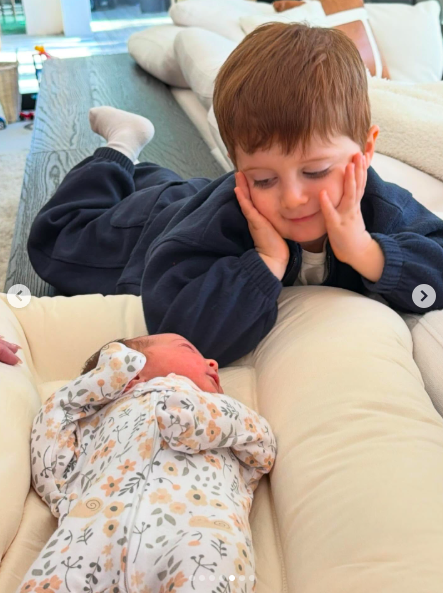 One of Meghan Trainor and Daryl Sabara's sons looking lovingly at his baby sister, Mikey Moon Trainor. | Source: Instagram/meghantrainor and darylsabara