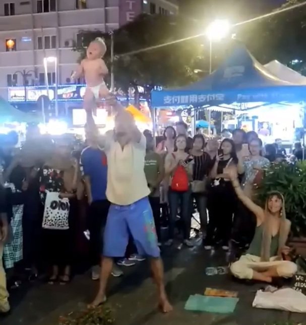 The father swinging the baby girl over his head l Source: Facebook / Zayl Chia Abdulla