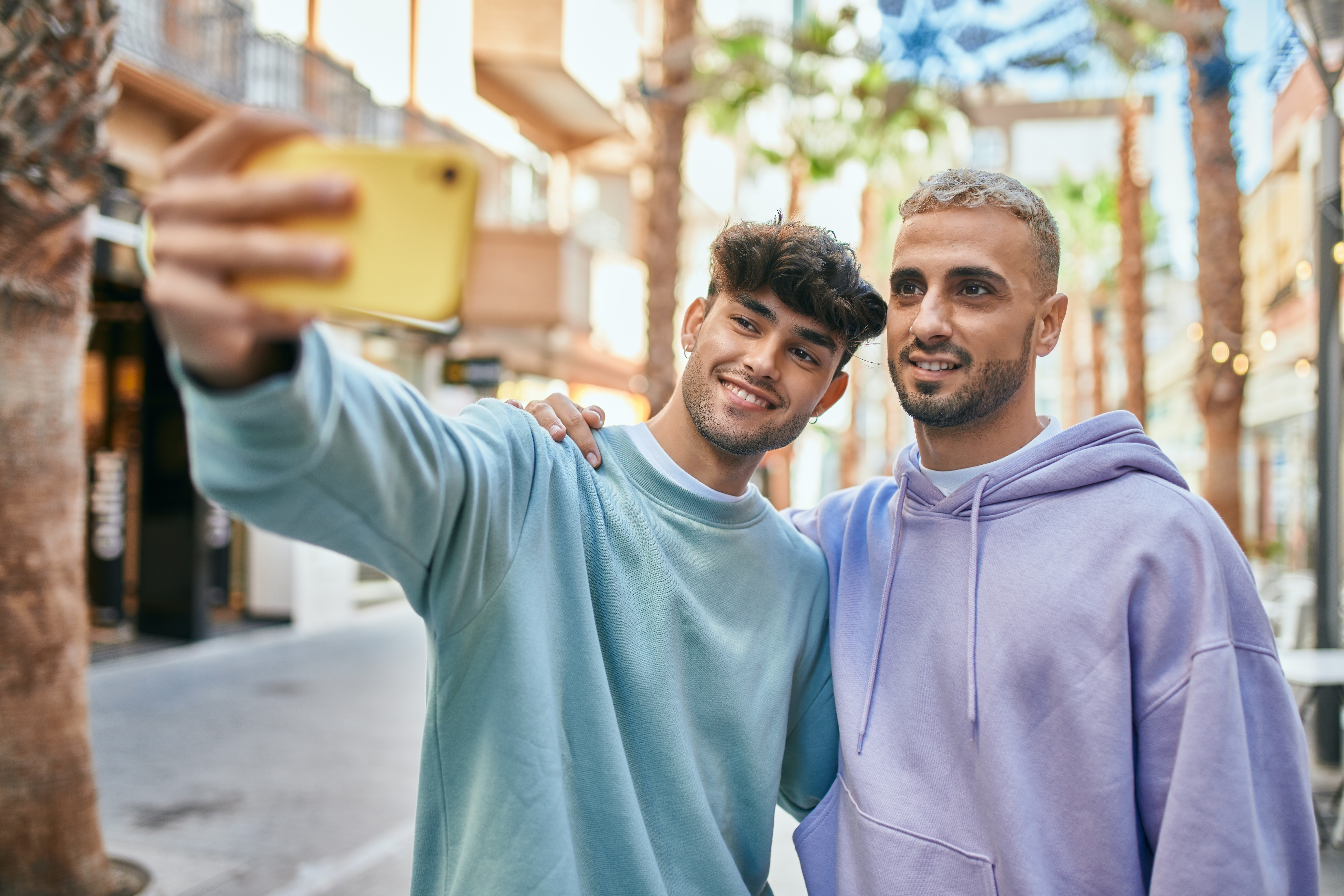 Two young men taking a photo together | Source: Shutterstock
