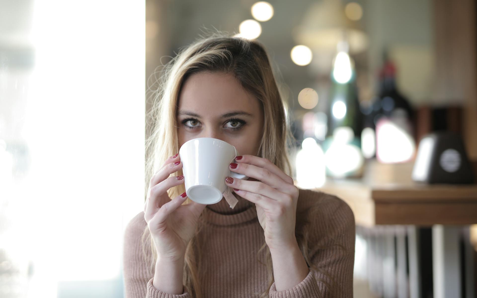 A woman drinking from a mug | Source: Pexels