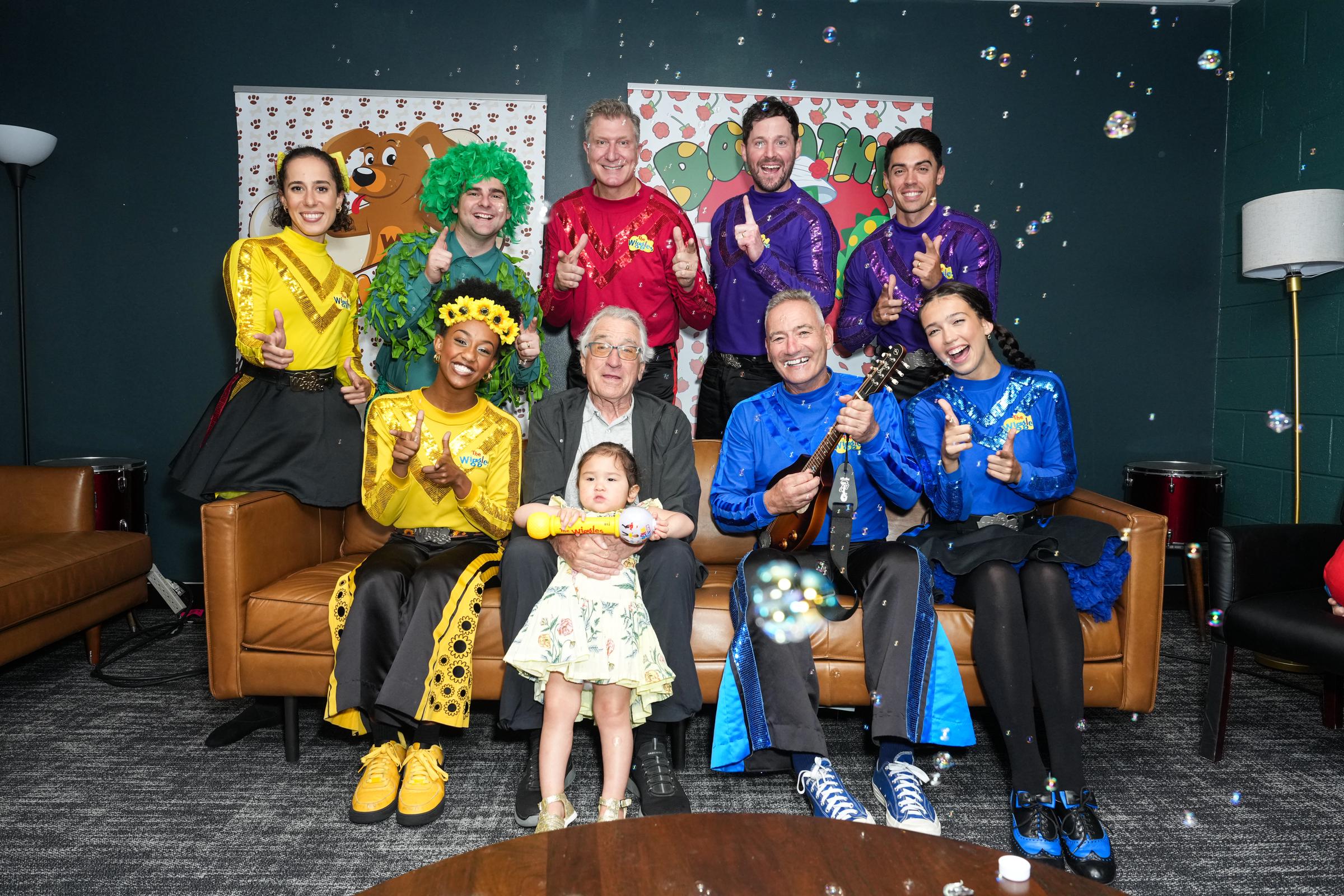 Robert De Niro and Gia Virginia Chen-De Niro surrounded by The Wiggles cast including Evie Ferris, Tsehay Hawkins, Dominic Field, Simon Pryce, Lachlan Gillespie, John Pearce, Anthony Field, and Lucia Field | Source: Getty Images