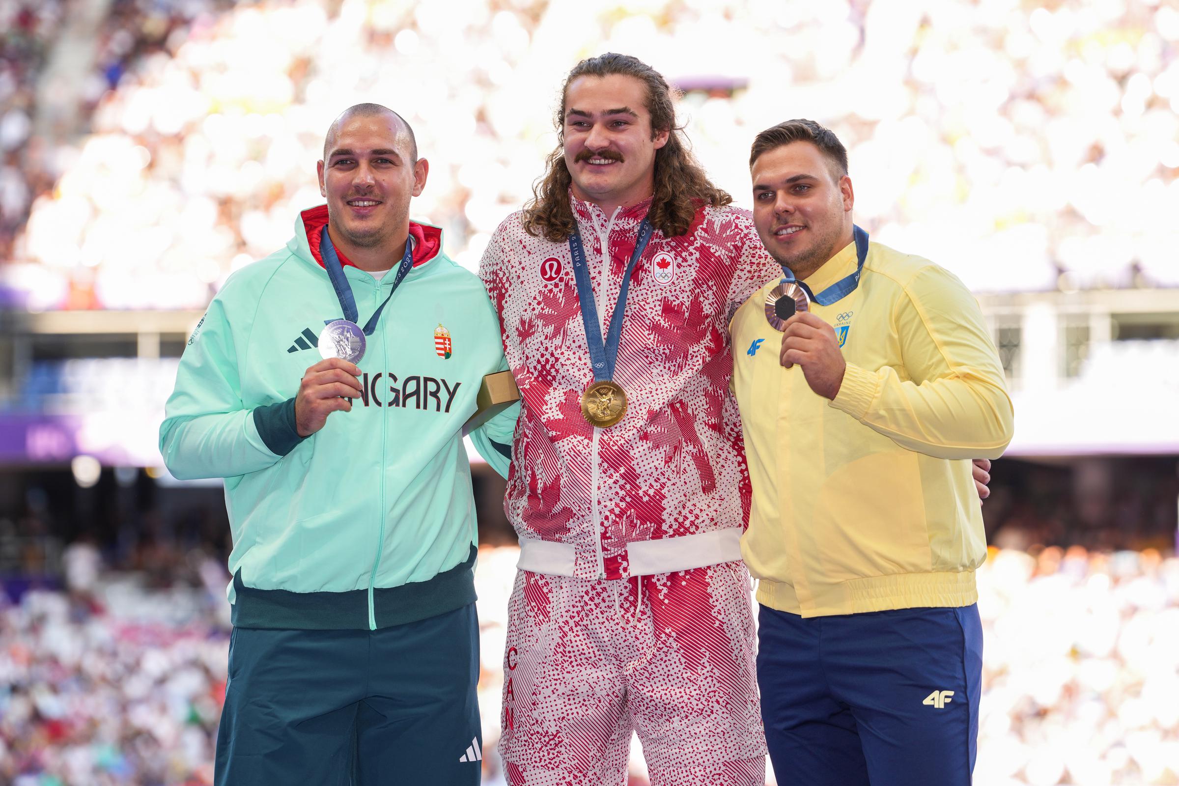 Silver medalist Bence Halasz of Hungary, Gold Medalist Ethan Katzberg of Canada and Bronze medalist Mykhaylo Kokhan of Ukraine pose on the podium during the victory ceremony during the Paris 2024 Olympics Games on August 5, 2024, in Paris, France. | Source: Getty Images