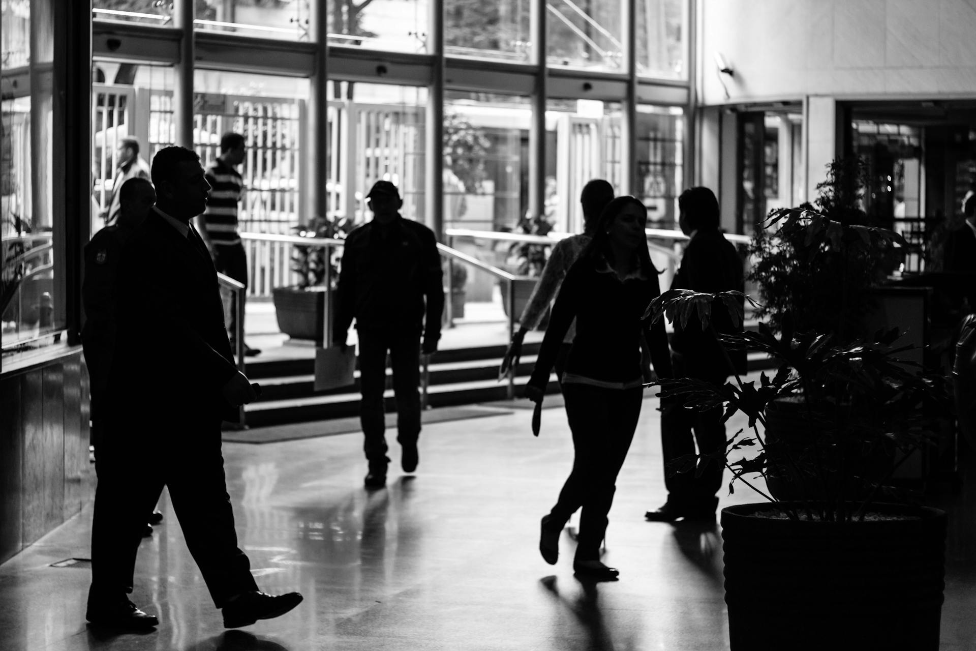 A grayscale photo of people in a building | Source: Pexels