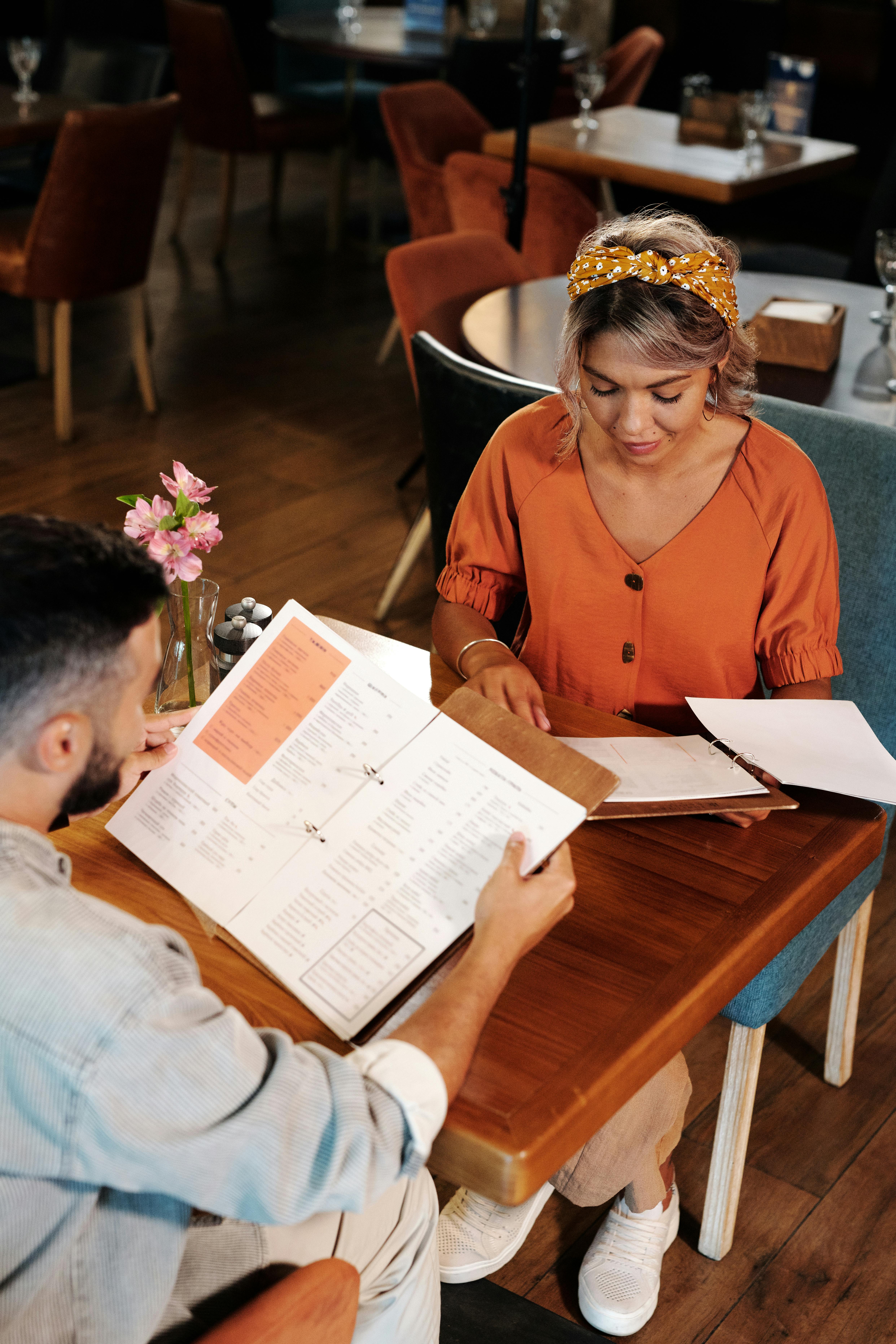 A man and a woman looking at the menu | Source: Pexels