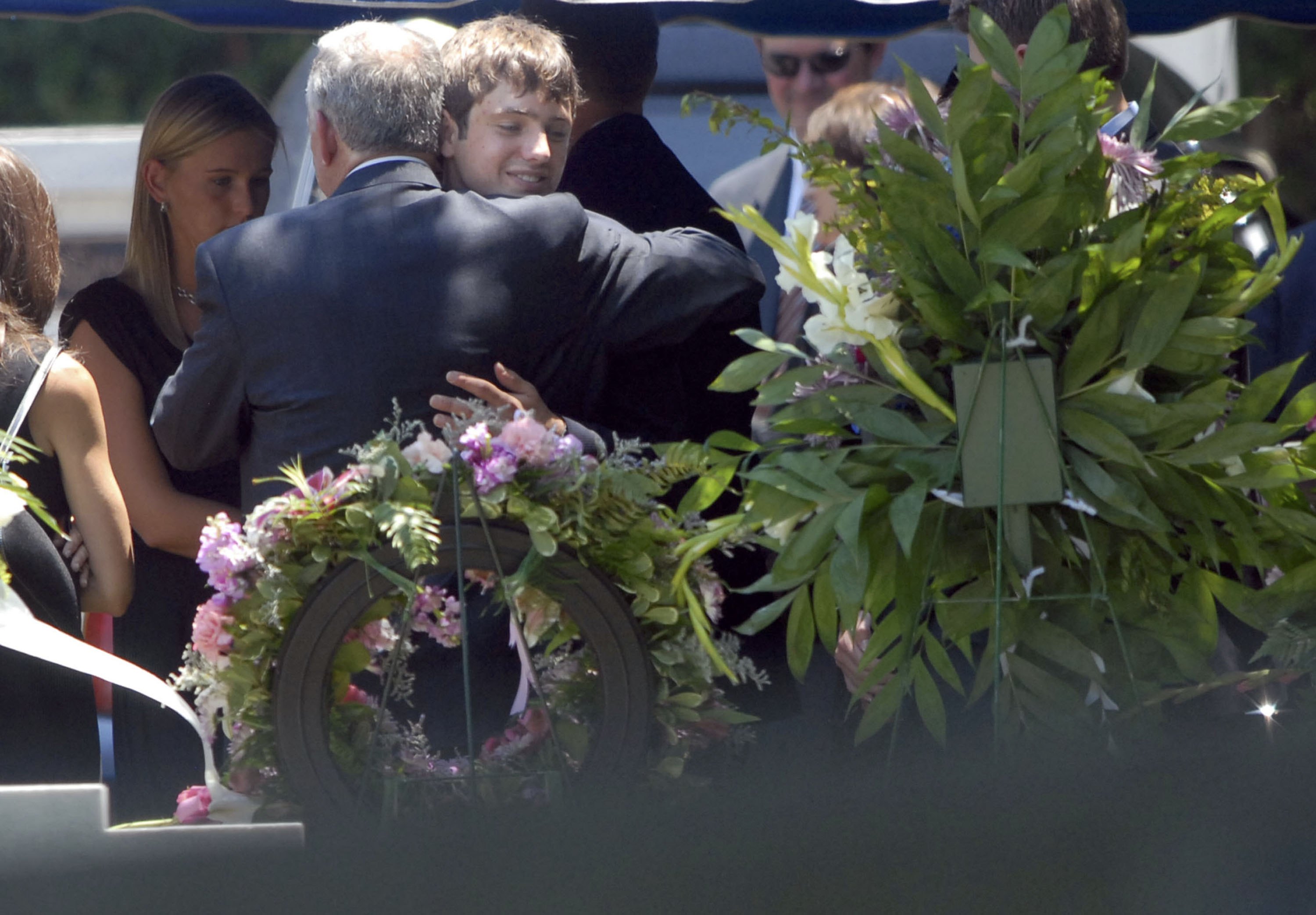 John Ramsey embraces Burke Ramsey at the grave of JonBenet Ramsey on June 29, 2006, in Marietta, Georgia. | Source: Getty Images