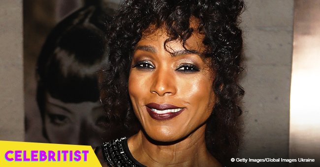Angela Bassett turns heads in sparkling purple pantsuit and plunging top 