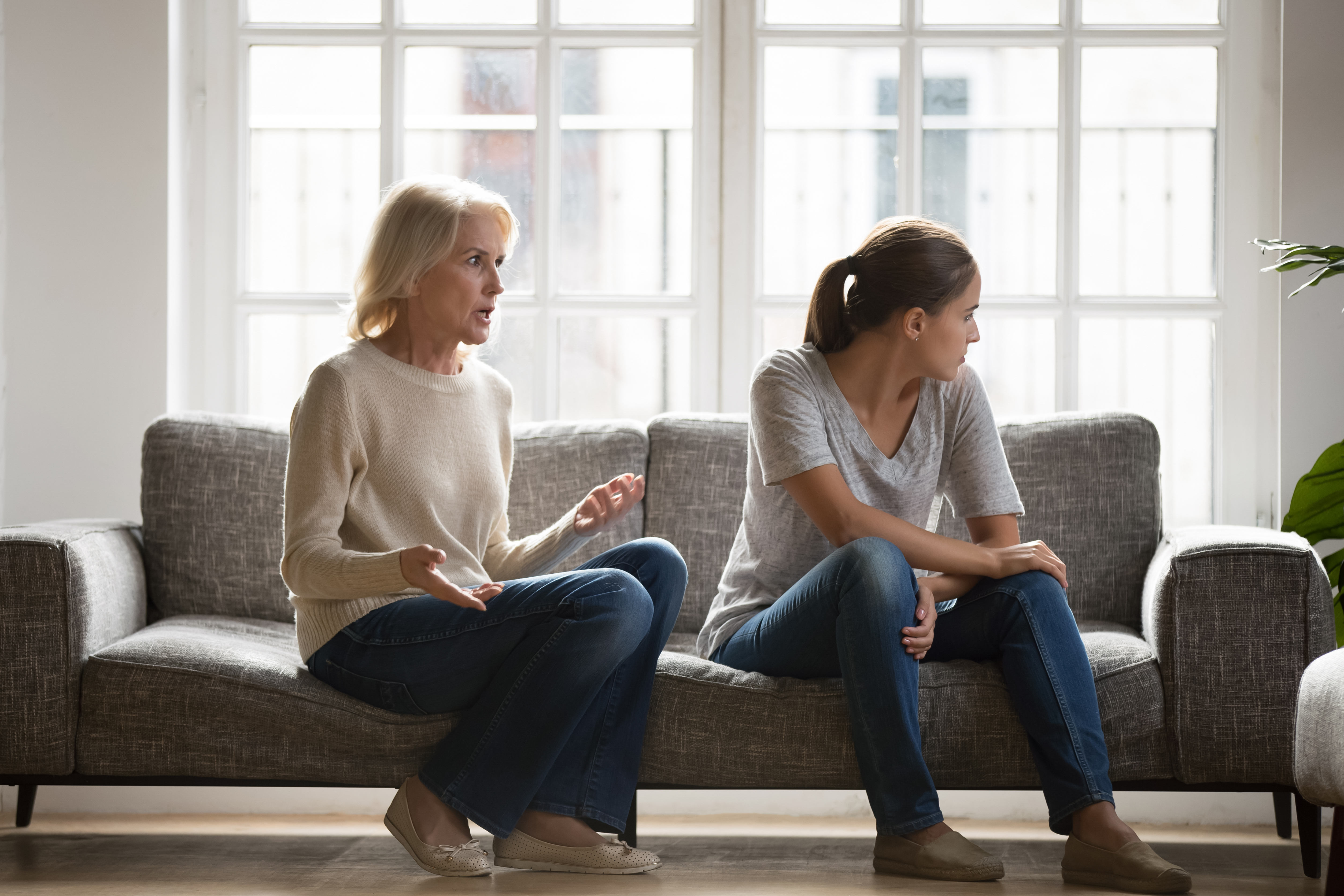 A stressed young woman disagreeing with her senior mom | Source: Shutterstock
