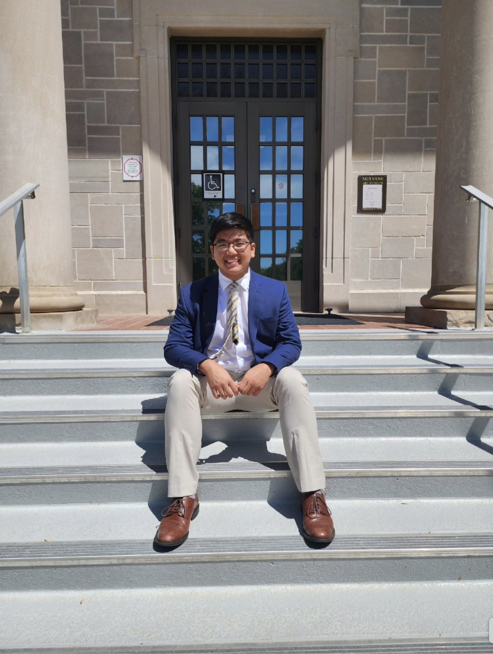 Austin Tran is seen sitting on the staircase, in a photo shared on May 6, 2025 | Source: Facebook/Austin Tran is seen at the University of Notre Dam, dated April 6, 2025 | Source: Facebook/anntravels2