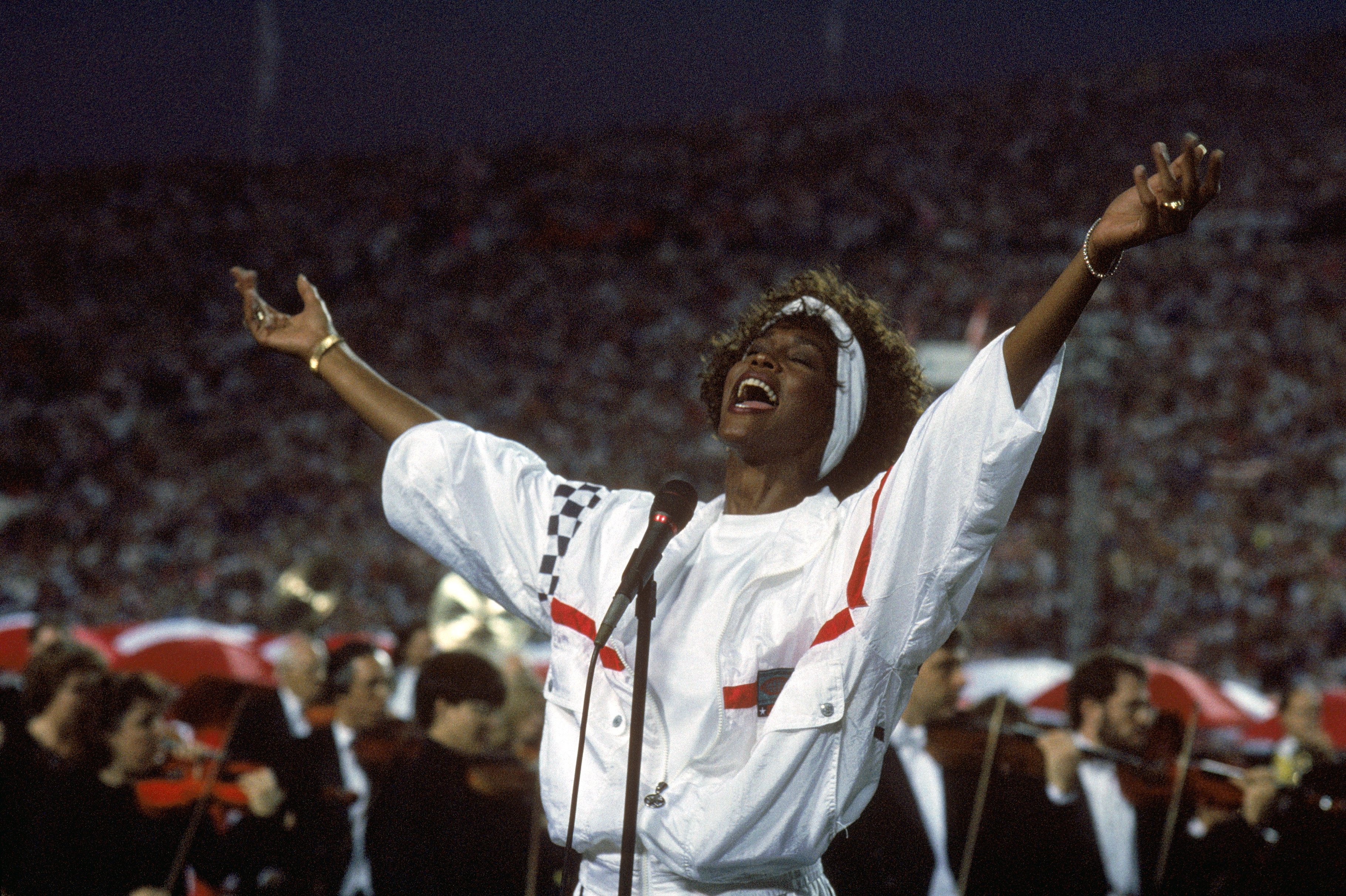 Whitney Houston cemented her name in the history books, when she delivered an astounding performance at the 1991 Super Bowl. | Photo: Getty Images. 