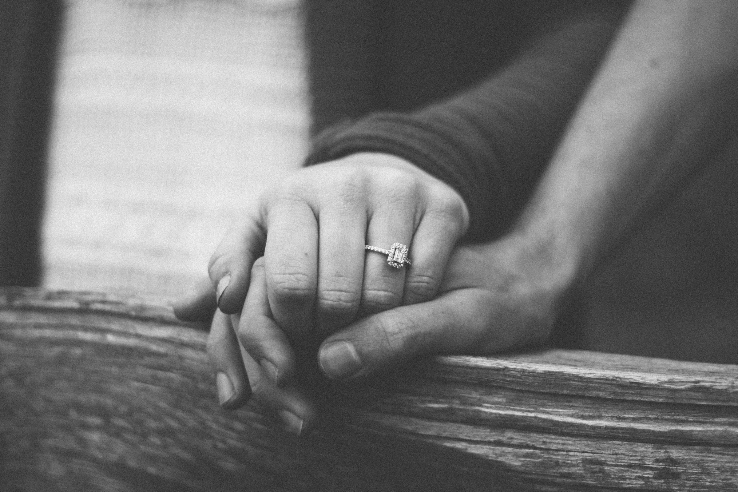 Grayscale shot of a couple holding hands | Source: Unsplash