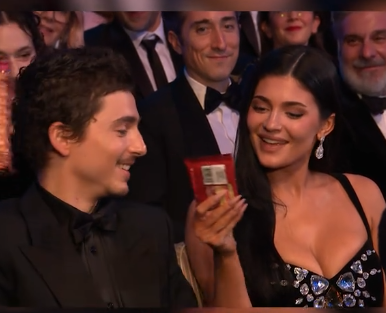 Timothée Chalamet and Kylie Jenner smiling after receiving a snack from Alan Cumming at the 79th BAFTA Film Awards dated February 22, 2026 | Source: TikTok/bbc