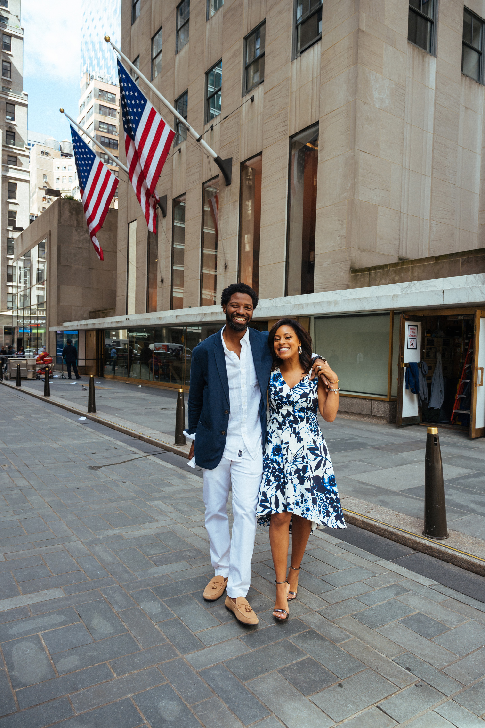 Sheinelle Jones and her husband Uche Ojeh are seen outside a building with American flags in 2019. | Source: Getty Images