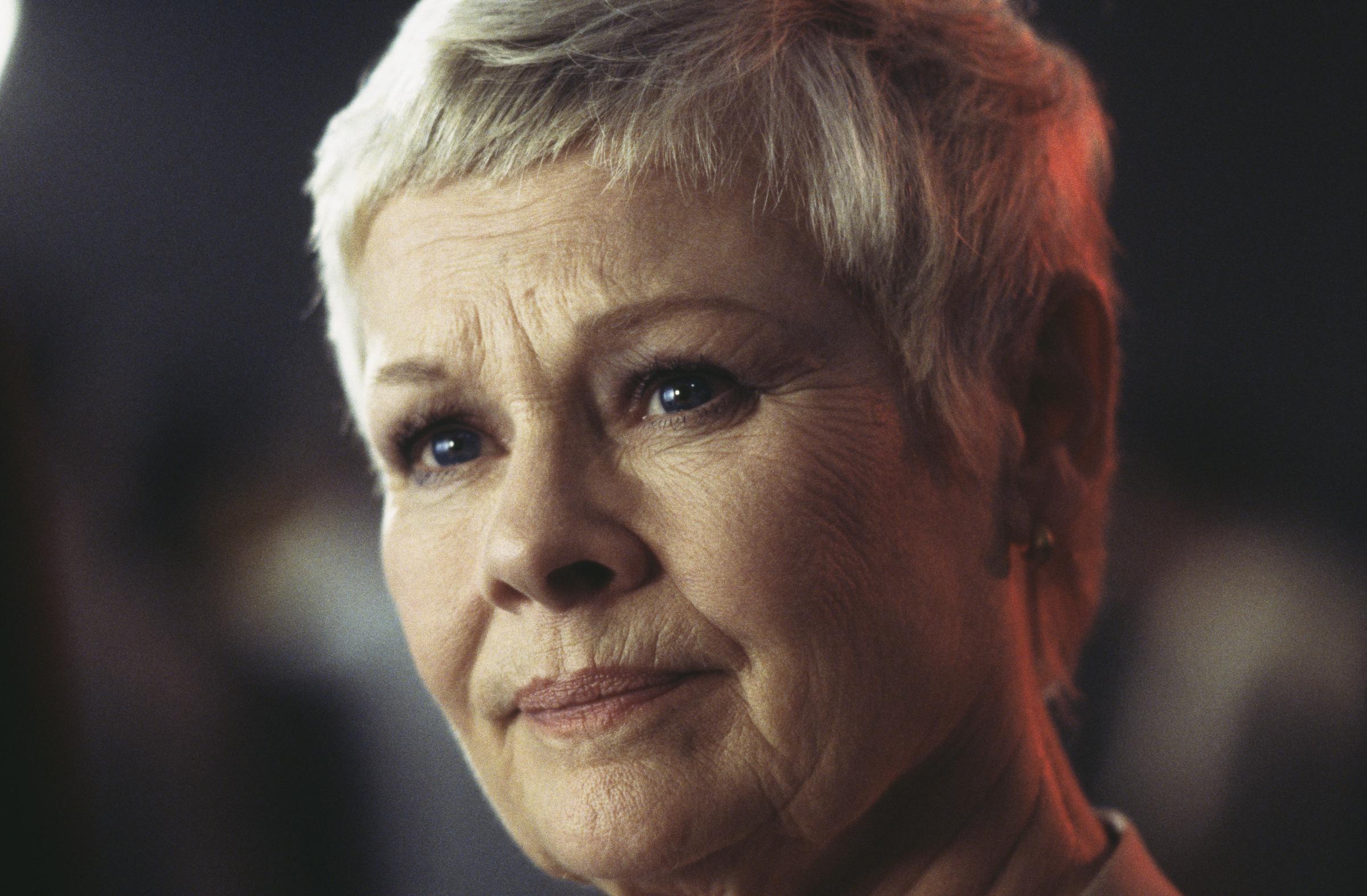 Judi Dench as M in the James Bond film "The World is Not Enough" in 1999. | Source: Getty Images
