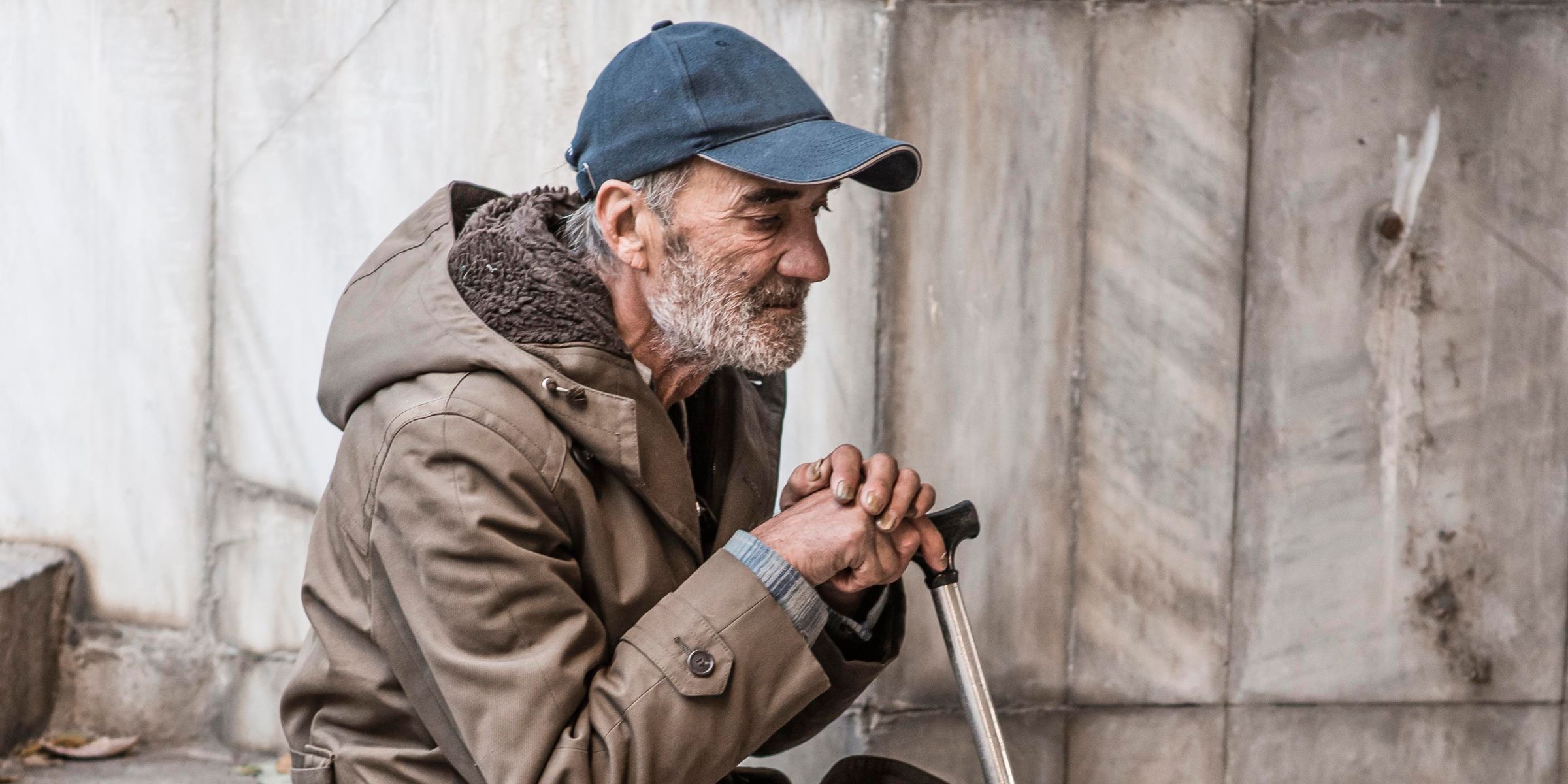 A homeless man sitting on stairs | Source: Freepik