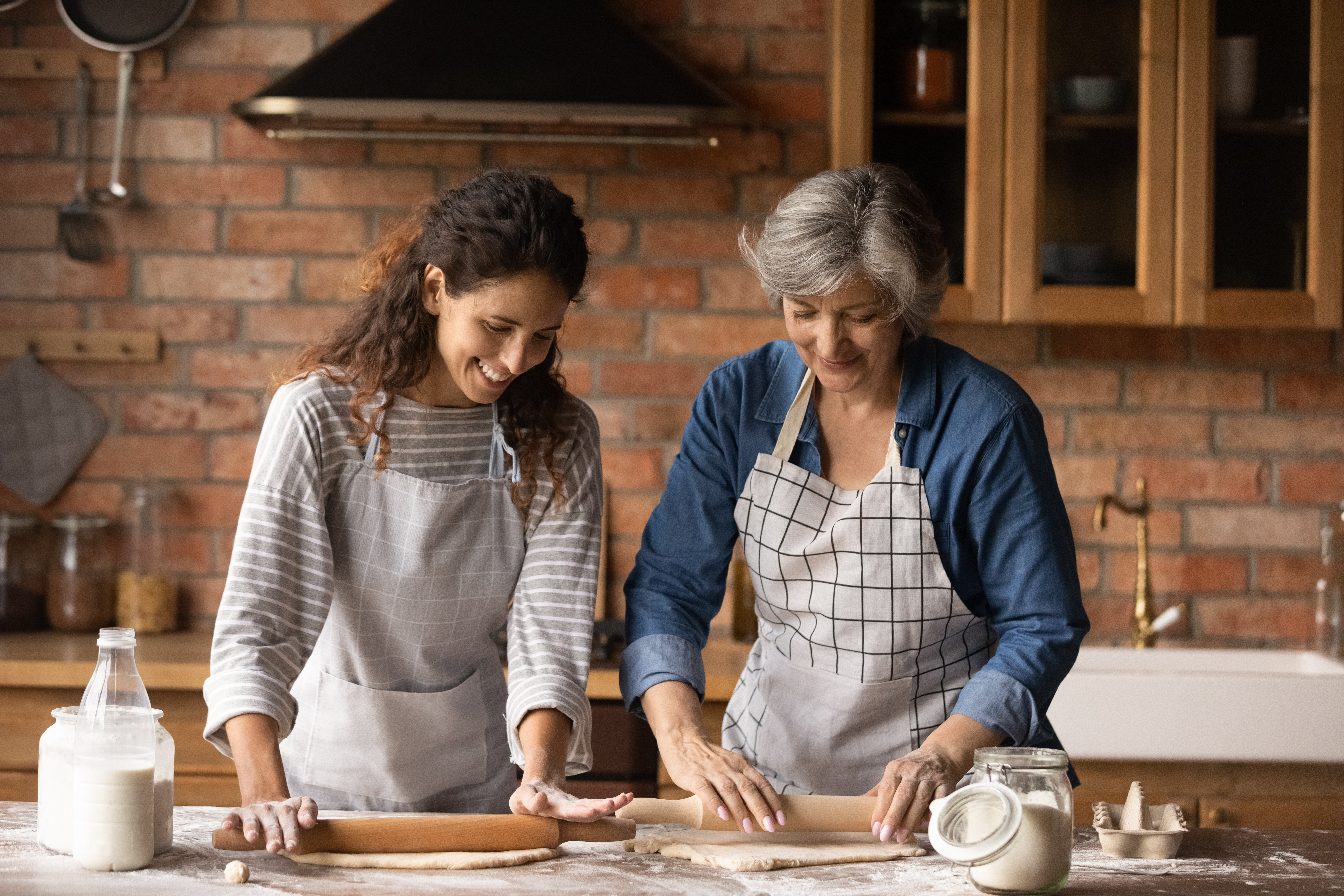 A young and an older women are cooking | Source: Shutterstock